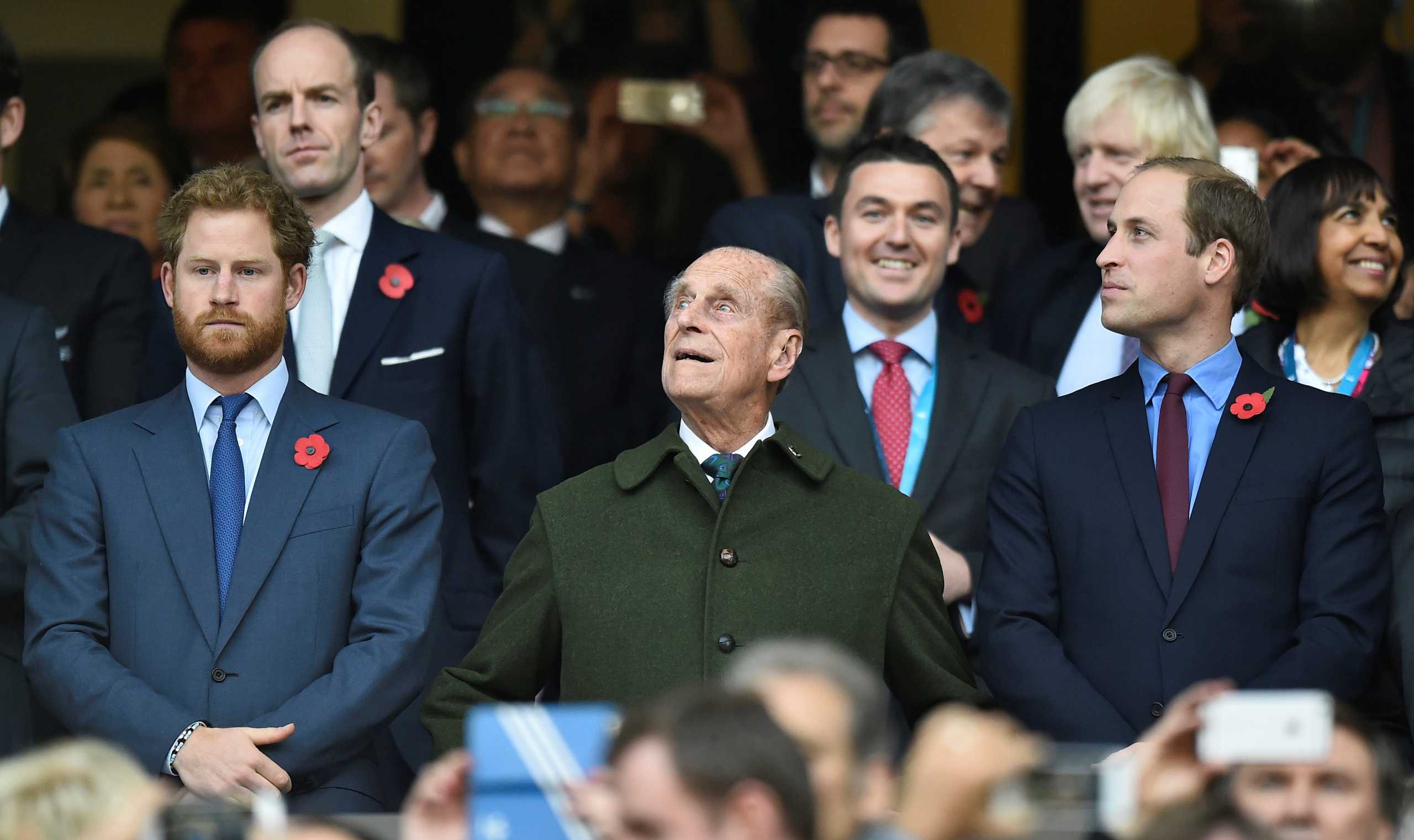 FILE PHOTO: Britain's Prince Harry, Prince Philip and Prince William (L-R) attend the Rugby World Cup final match between New Zealand against Australia at Twickenham in London, Britain October 31, 2015.    REUTERS