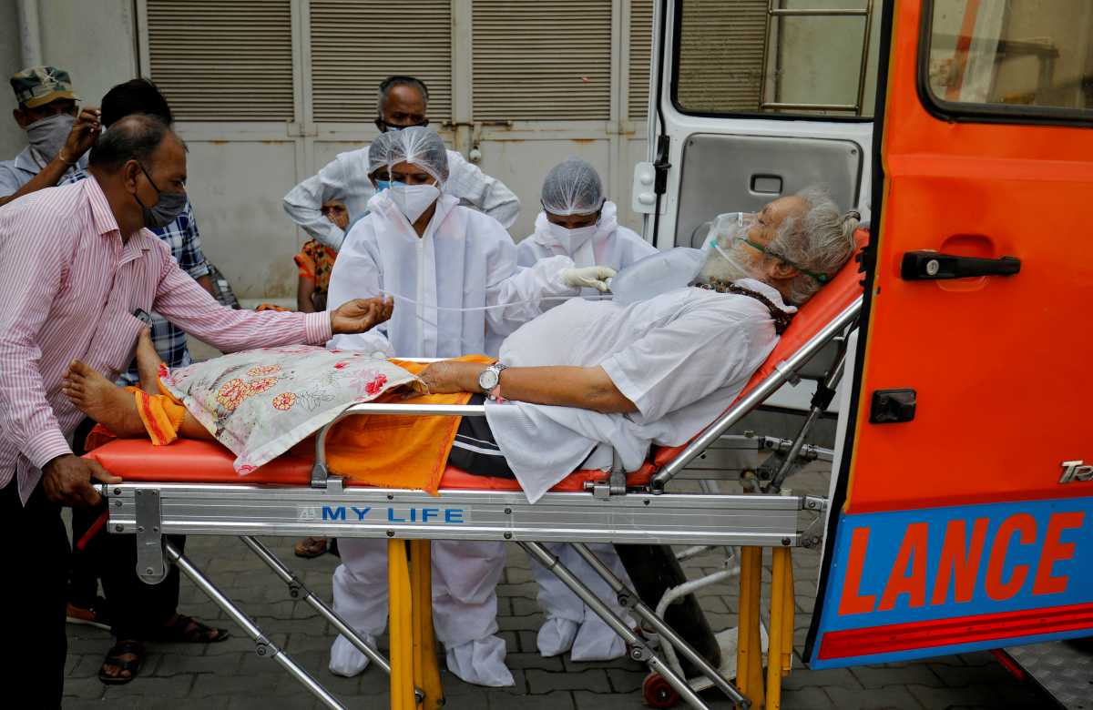 FILE PHOTO: A patient wearing an oxygen mask is wheeled inside a COVID-19 hospital for treatment, amidst the spread of the coronavirus disease (COVID-19) in Ahmedabad, India, April 26, 2021. REUTERS