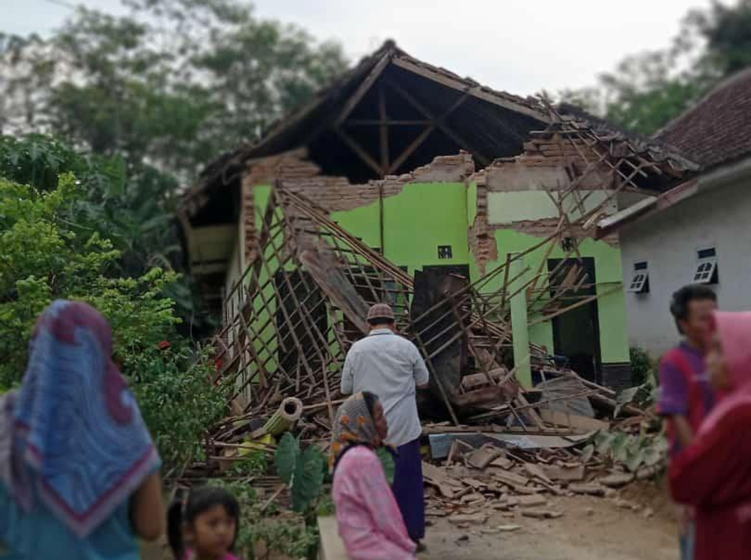 A damaged house affected by an earthquake of magnitude 5.9 struck in the ocean 91 km (57 miles) south-southeast of Blitar, is pictured in Malang, East Java province, Indonesia April 10, 2021, in this photo taken by Antara Foto