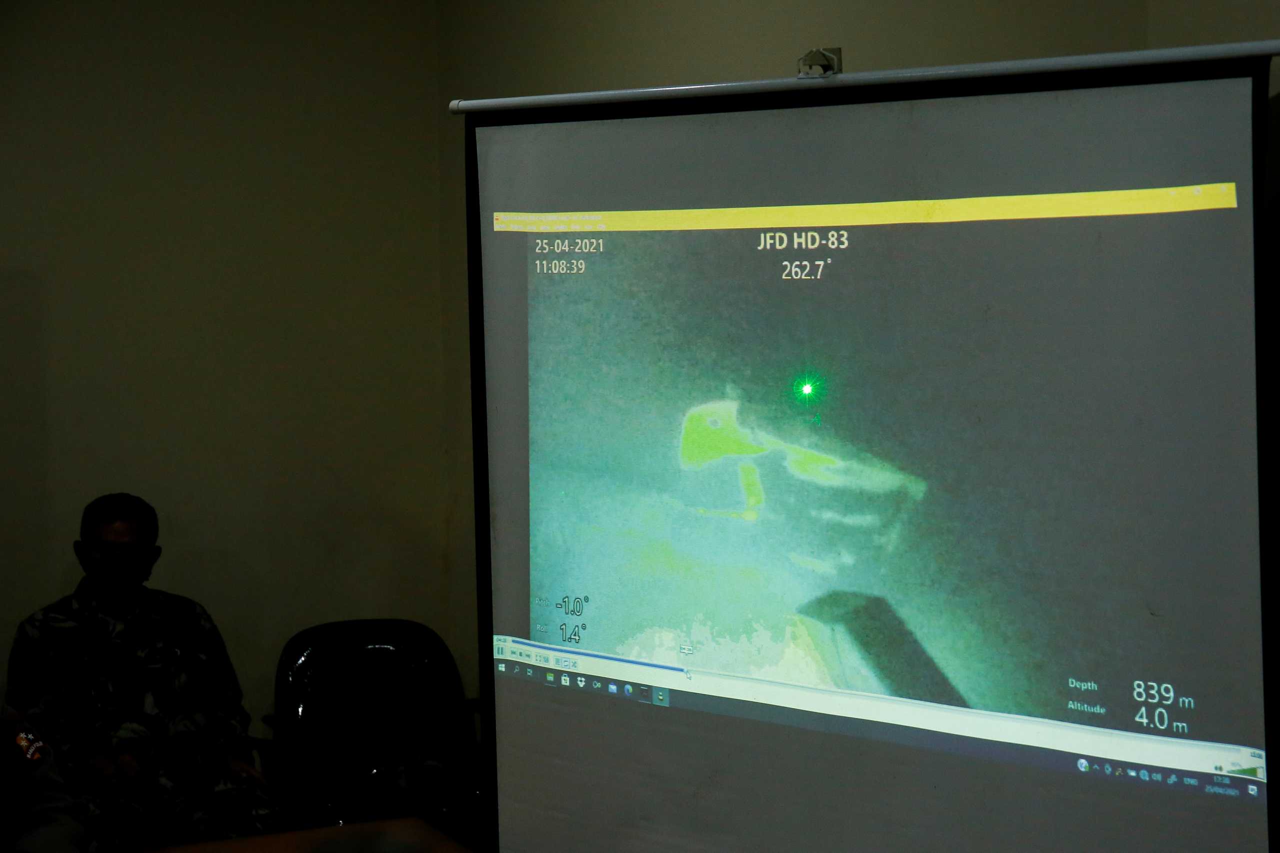 The military personnel display a video showing what is believed to be the sunken Indonesian Navy KRI Nanggala-402 submarine during a media conference at I Gusti Ngurah Rai Airport in Bali, Indonesia, April 25, 2021. REUTERS