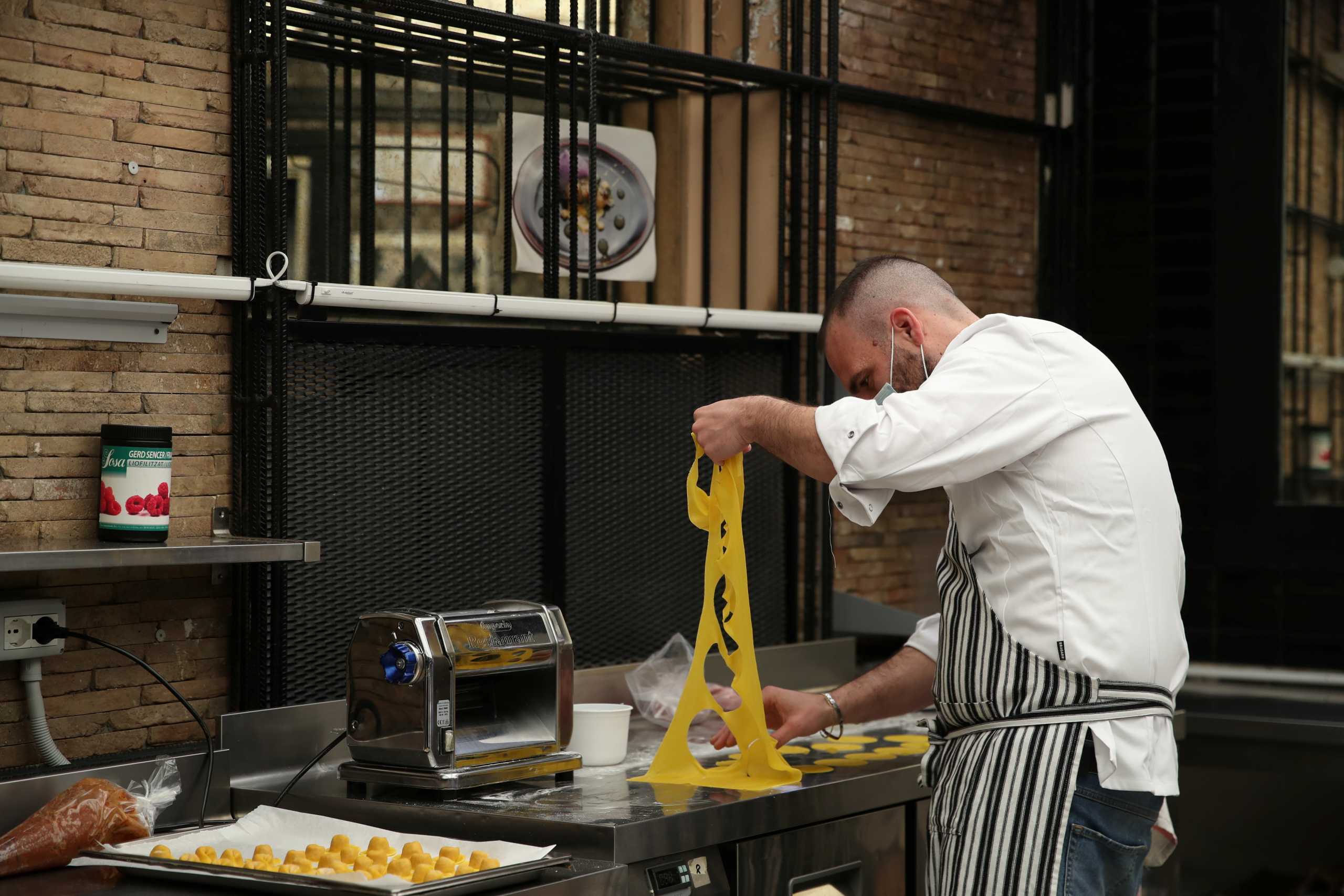 Chef Marco Martini, owner of one-Michelin-starred "Marco Martini" restaurant, makes fresh pasta as owners prepare outdoor dining in order to be ready for April 26 when restrictions to contain the spread of the coronavirus disease (COVID-19) will relax and people can dine outside, in Rome, Italy, April 23, 2021. REUTERS
