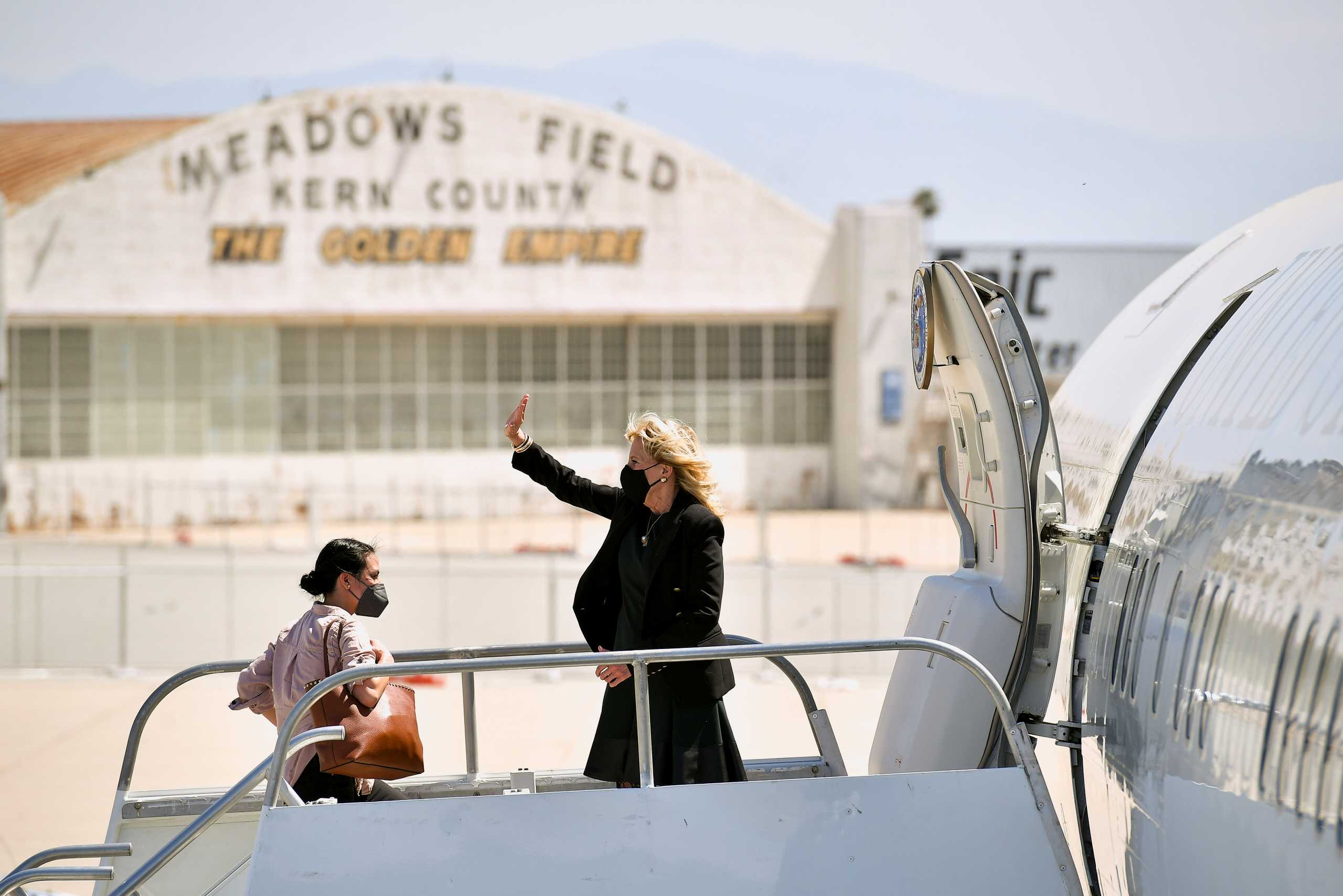 U.S. first lady Jill Biden waves as she boards a plane before departing from Meadows Field Airport in Bakersfield, California, U.S., April 1, 2021. Mandel Ngan