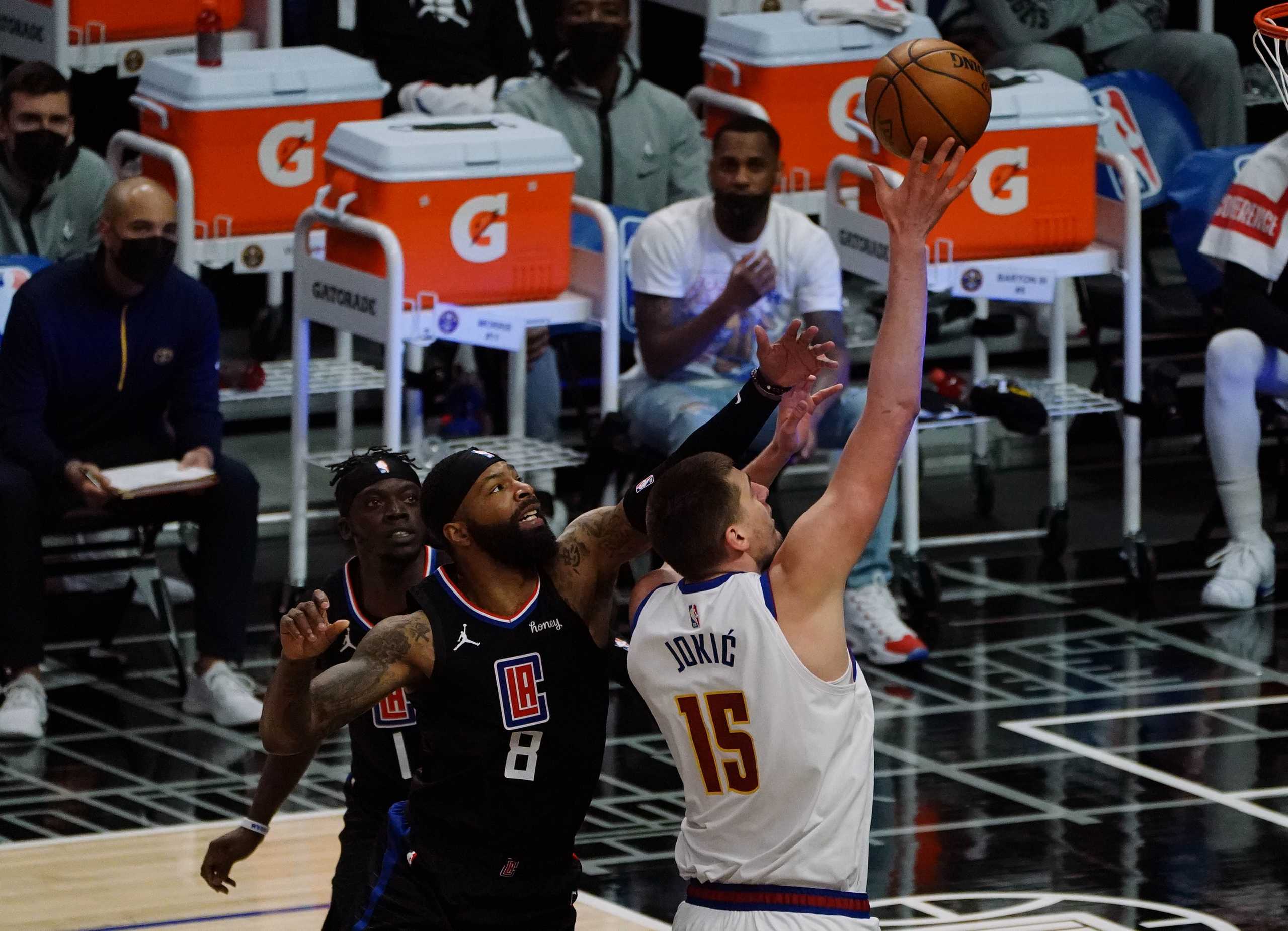 Apr 1, 2021; Los Angeles, California, USA; Denver Nuggets center Nikola Jokic (15) shoots against Los Angeles Clippers forward Marcus Morris Sr. (8) during the first half at Staples Center. Mandatory Credit: Gary A. Vasquez-USA TODAY Sports