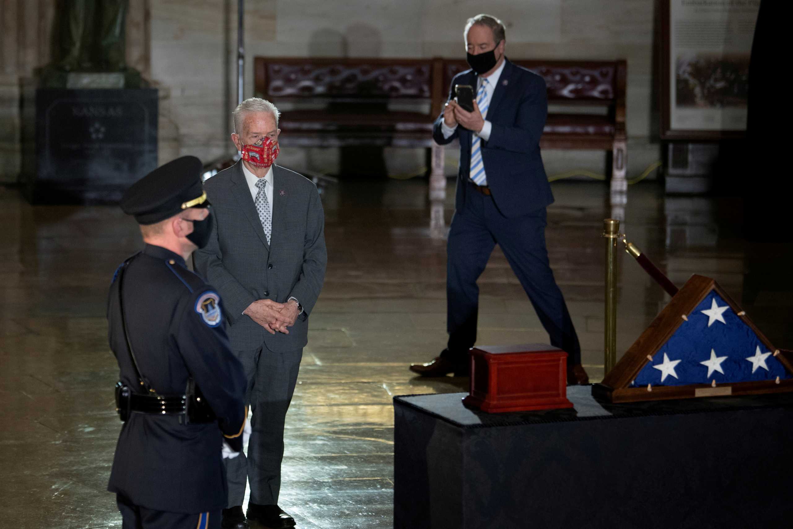 FILE PHOTO: U.S. Representative John Joyce (R-PA) takes a picture of U.S. Representative Bill Johnson (R-OH) at the remains of U.S. Capitol Police Officer Brian D. Sicknick, 42, as he lies in state in the Rotunda of the U.S. Capitol, in Washington, DC, U.S, February 3, 2021. Brendan Smialowski