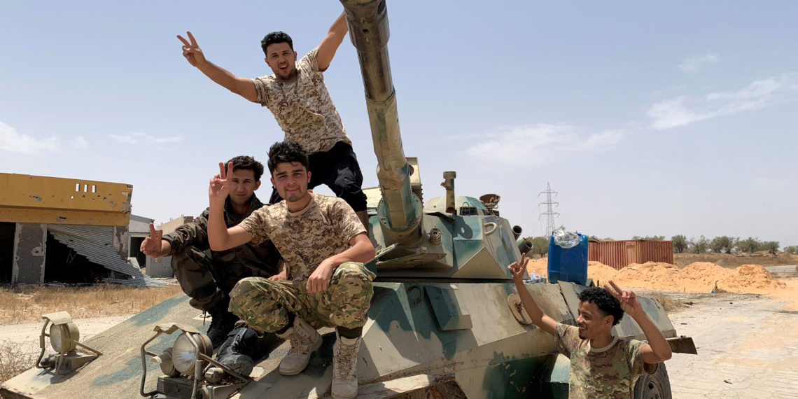 FILE PHOTO: Fighters loyal to Libya's internationally recognised government celebrate after regaining control over the city, in Tripoli, Libya, June 4, 2020. REUTERS