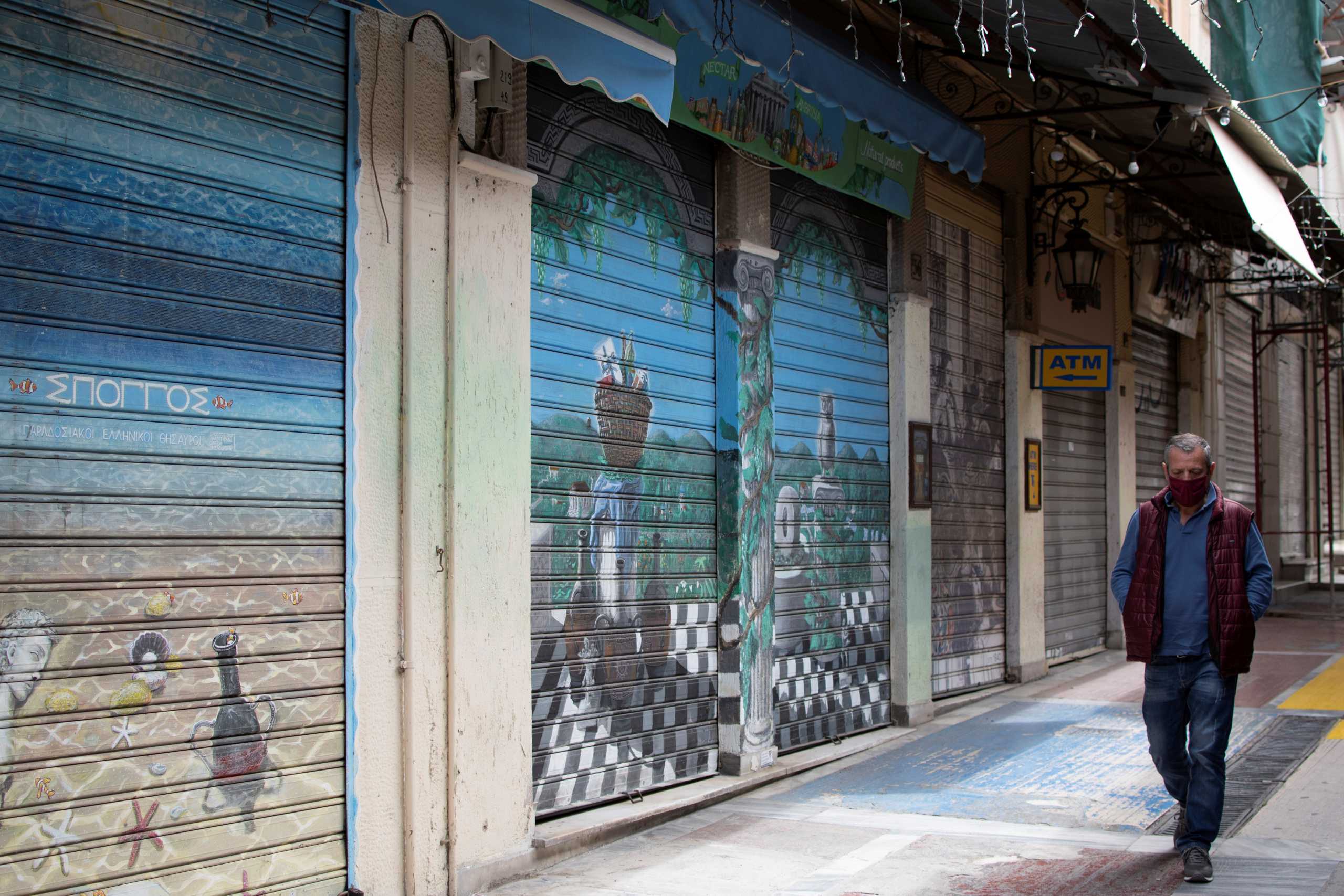 A man wearing a protective face mask walks past closed shops in the Monastiraki area, amid the coronavirus disease (COVID-19) pandemic in Athens, Greece April 4, 2021. REUTERS