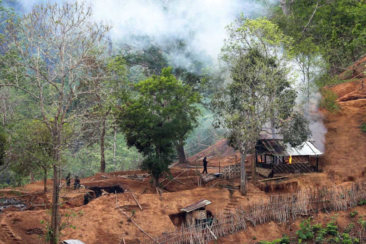 Ethnic minority Karen troops are seen after setting fire to a building inside a Myanmar army outpost near the Thai border, which is seen from the Thai side on the Thanlwin, also known as Salween, riverbank in Mae Hong Son province, Thailand, April 28, 2021. REUTERS