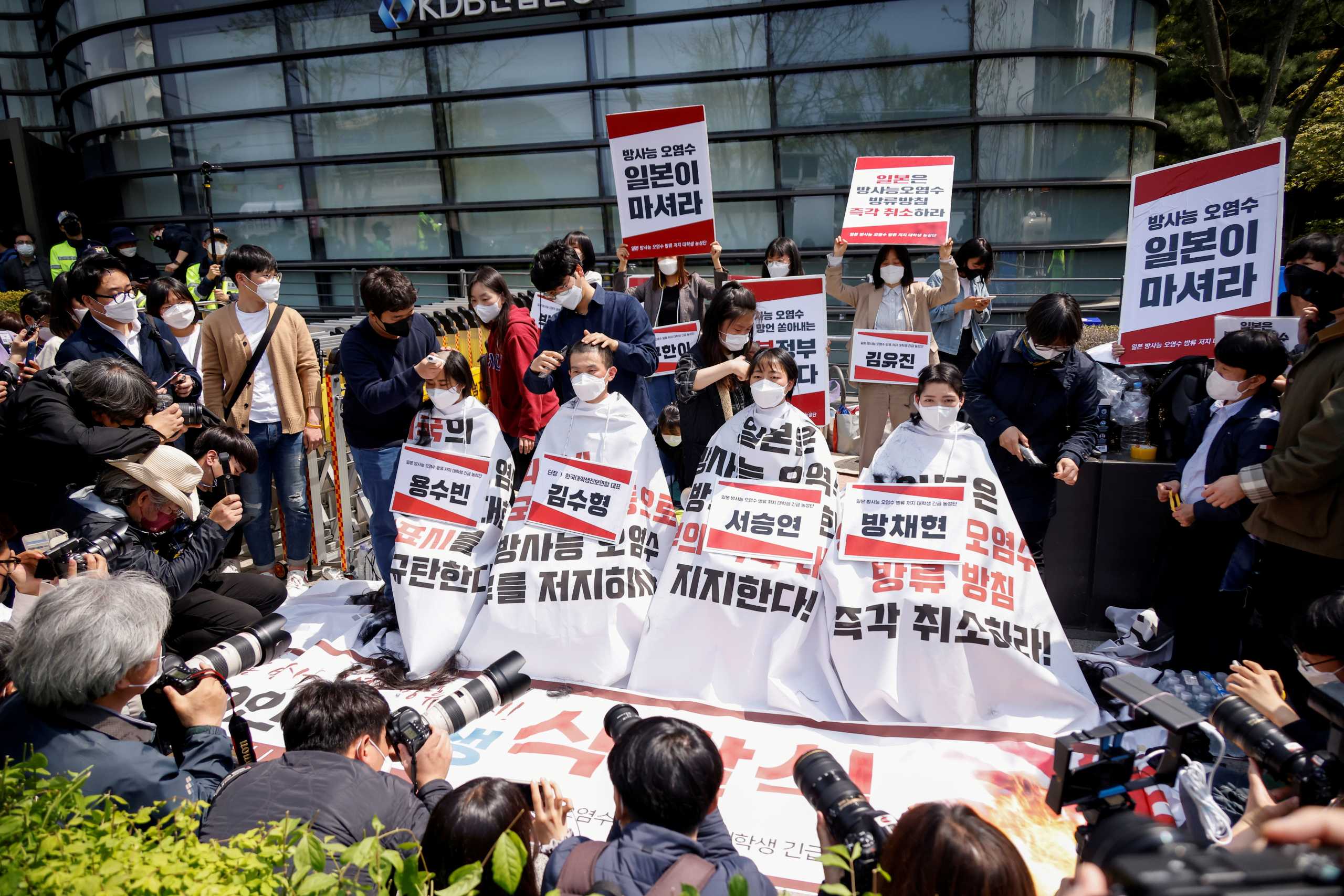 South Korea university students gets their heads shaved during a protest against Japan?s decision to release contaminated water from its crippled Fukushima nuclear plant into the sea, in front of the Japanese embassy, in Seoul, South Korea, April 20, 2021.  REUTERS