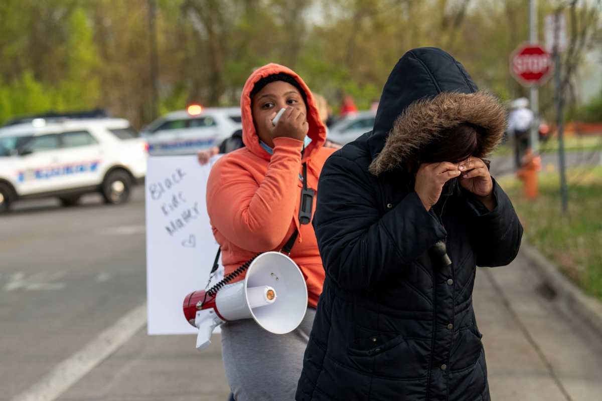 Crowds react as investigators work at the scene where 15-year-old Makiyah Bryant was fatally shot by a police officer in Columbus, Ohio, U.S., April 20, 2021.  REUTERS