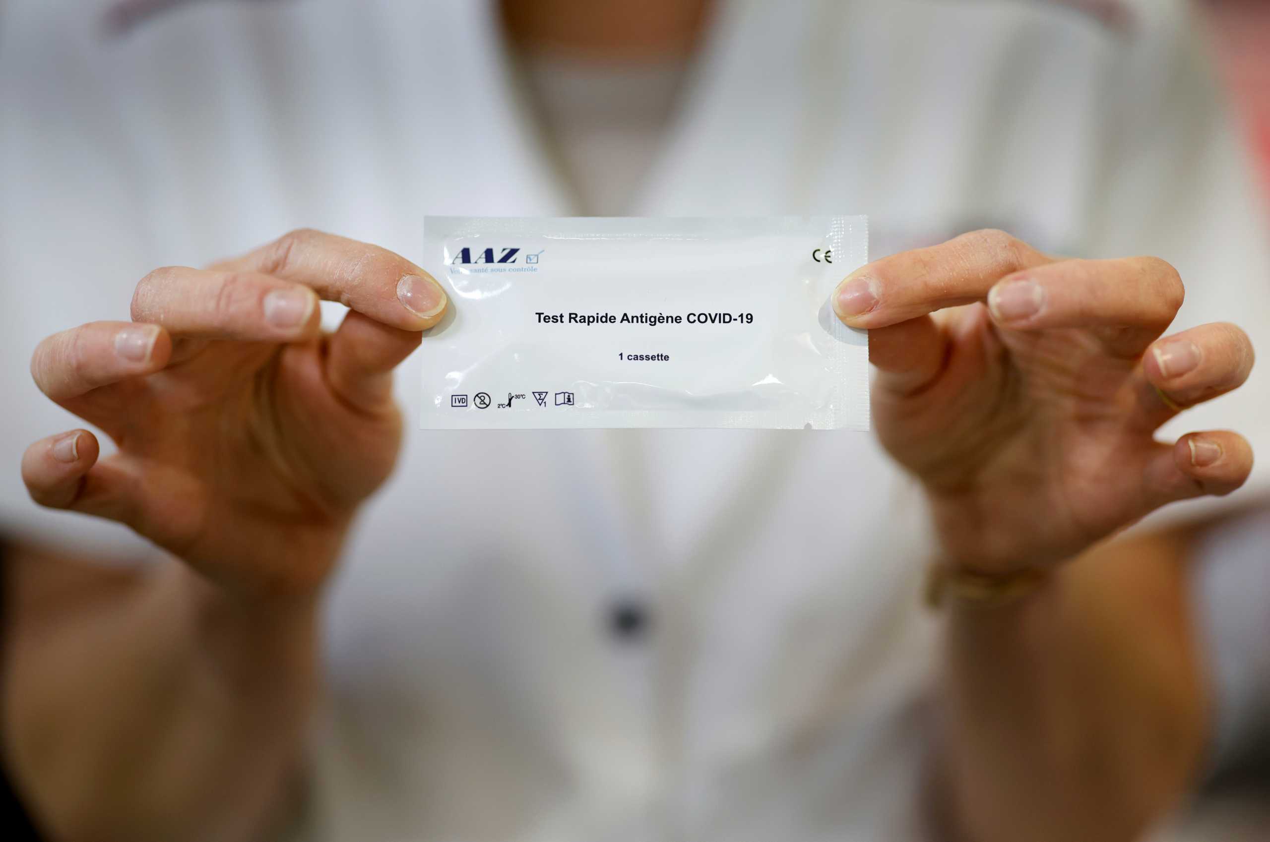 A pharmacist shows a COVID-19 self-test kit in a pharmacy in Nantes amid the coronavirus disease (COVID-19) outbreak  in France, April 13, 2021. REUTERS