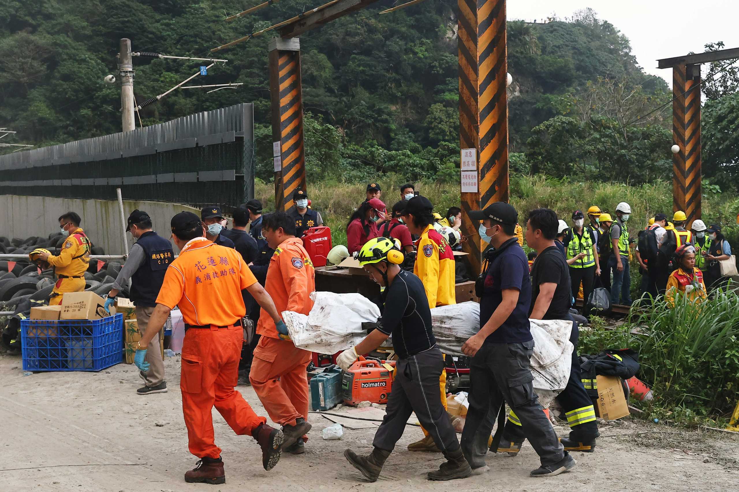 Rescuers carry a body on a stretcher at the site after a train derailed in a tunnel north of Hualien, Taiwan April 2, 2021. REUTERS