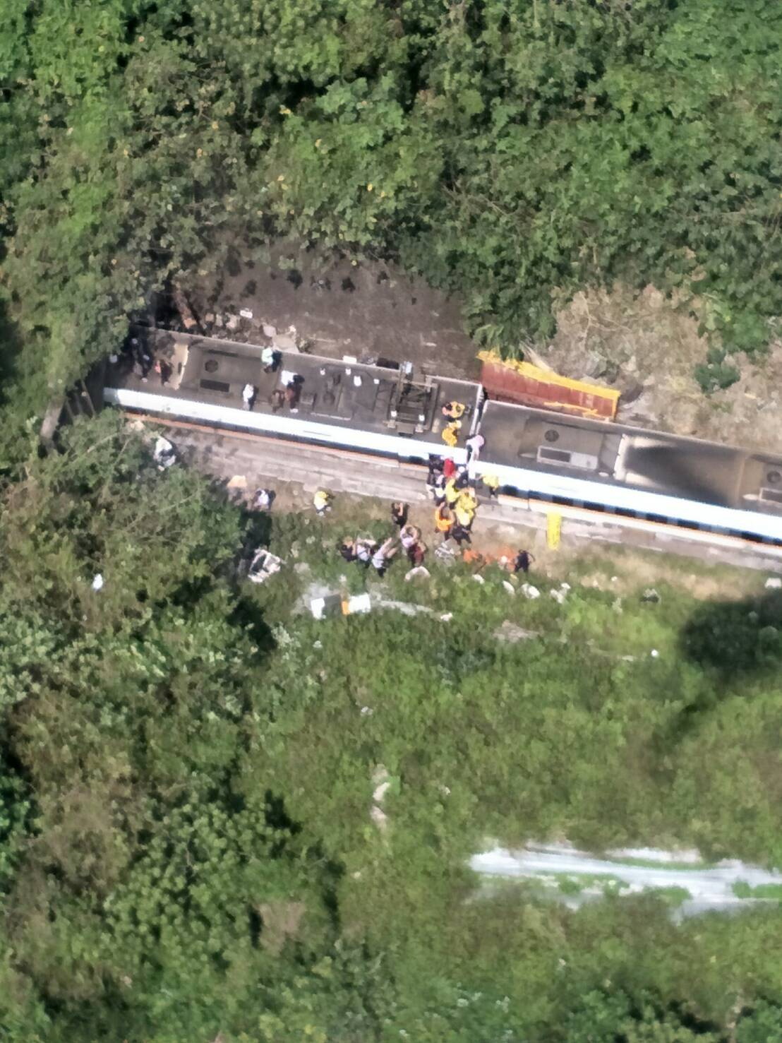 Rescue workers are seen by a train which derailed in a tunnel north of Hualien, Taiwan April 2, 2021, in this handout image provided by Taiwan's National Fire Agency. Taiwan's National Fire Agency