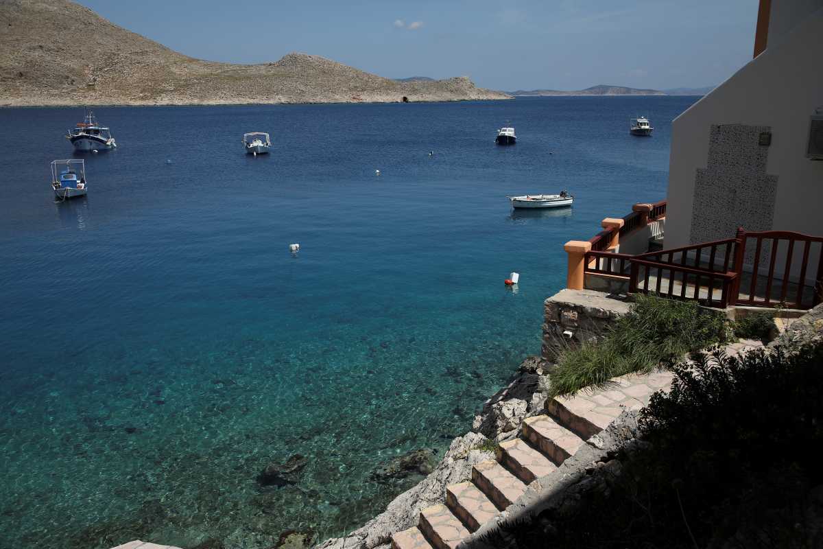 Boats are anchored off the port of Halki, amid the coronavirus disease (COVID-19) pandemic, on the island of Halki, Greece, April 13, 2021. Picture taken April 13, 2021. REUTERS