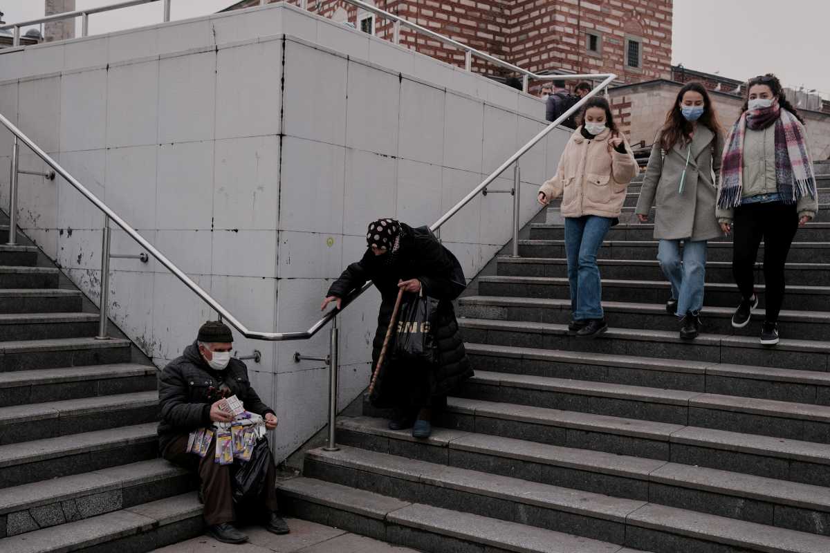 FILE PHOTO: People wearing protective masks stroll at Eminonu district, amid the coronavirus disease (COVID-19) outbreak, in Istanbul, Turkey April 5, 2021. REUTERS