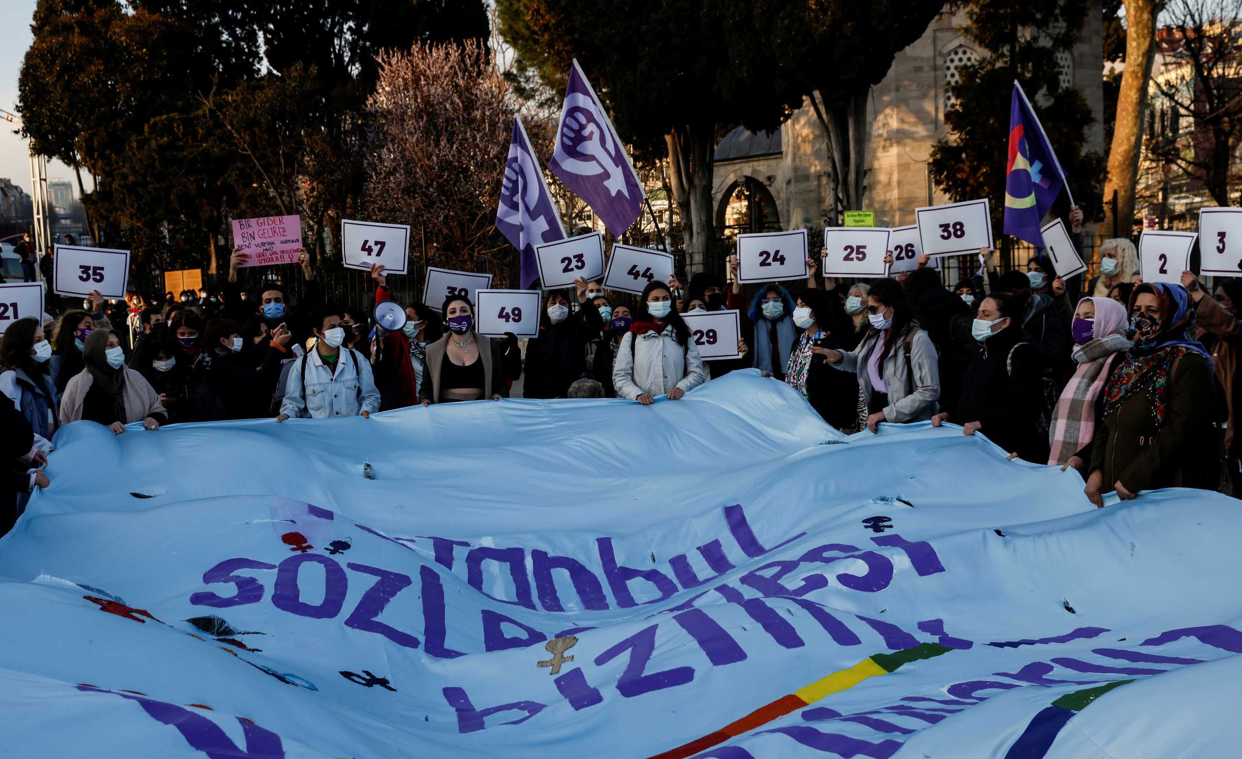 Activists hold banners during a protest against Turkey's withdrawal from Istanbul Convention, an international accord designed to protect women, in Istanbul, Turkey, April 2, 2021. REUTERS