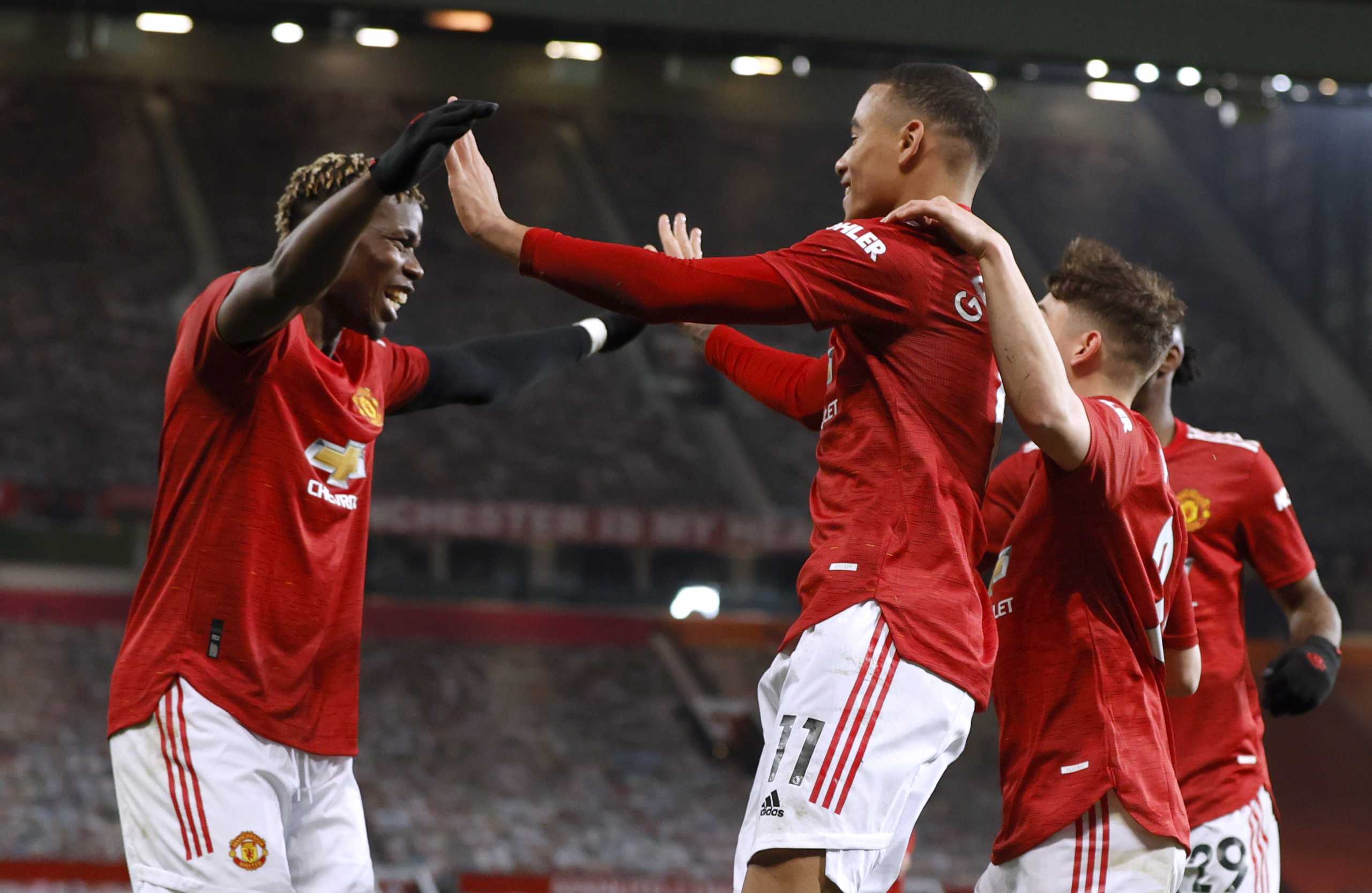 Soccer Football - Premier League - Manchester United v Brighton & Hove Albion - Old Trafford, Manchester, Britain - April 4, 2021 Manchester United's Mason Greenwood celebrates scoring their second goal with teammates Pool via REUTERS