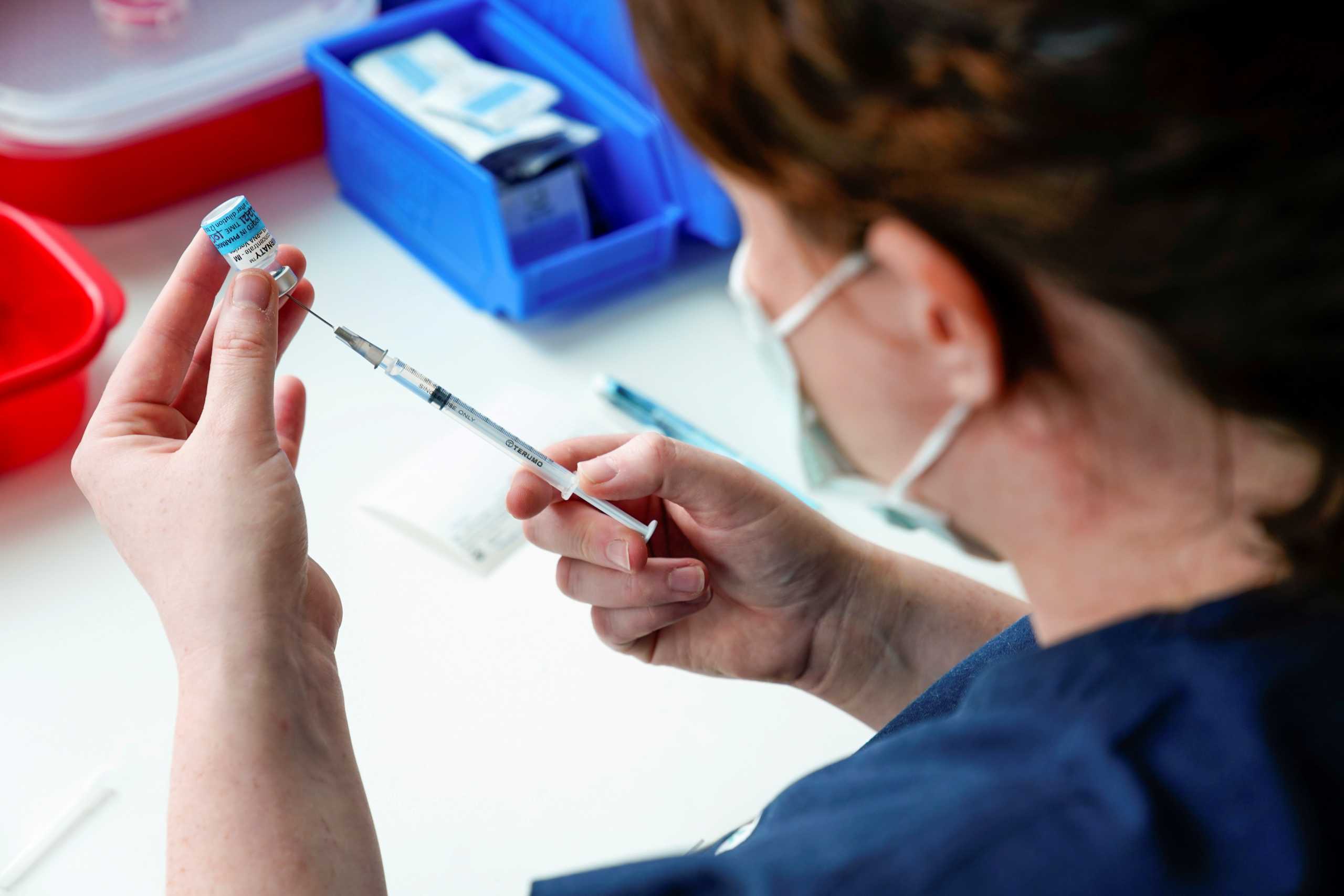 FILE PHOTO: A healthcare professional prepares a dose of the Pfizer coronavirus disease (COVID-19) vaccine as high-risk workers receive the first vaccines in the state of Victoria's rollout of the program, in Melbourne, Australia, February 22, 2021.  REUTERS