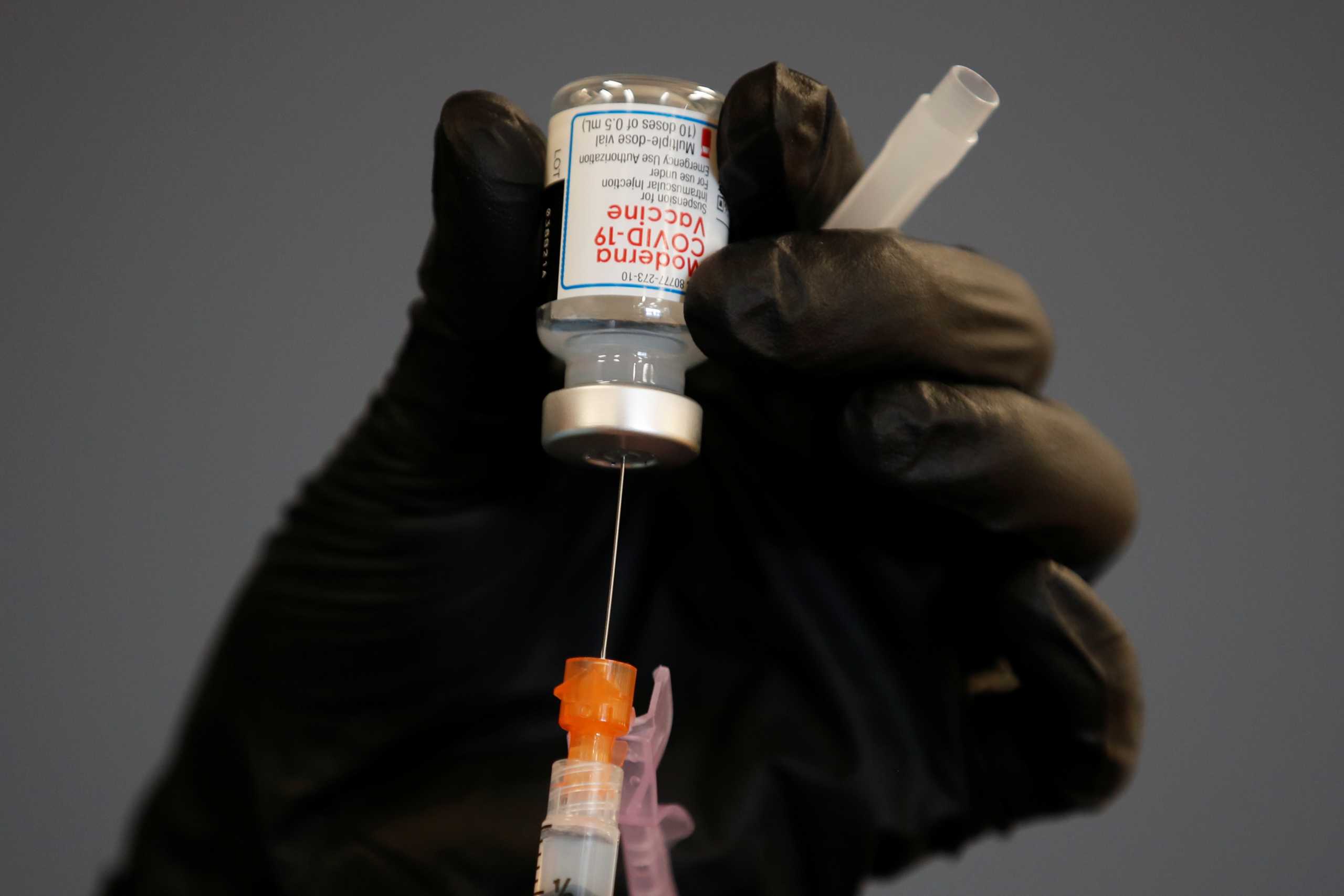 A health care worker fills a syringe with Moderna COVID-19 vaccine as California opens up vaccine eligibility to any residents 16 years and older during the outbreak of coronavirus disease (COVID-19) in Chula Vista, California, U.S., April 15, 2021.  REUTERS