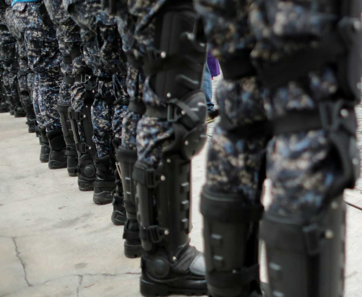 Officers of the Bolivarian National Police block the street before a procession with the statue of The Nazarene of St. Paul during Holy Week celebrations in the neighbourhood Catia, in Caracas, Venezuela March 31, 2021.  REUTERS