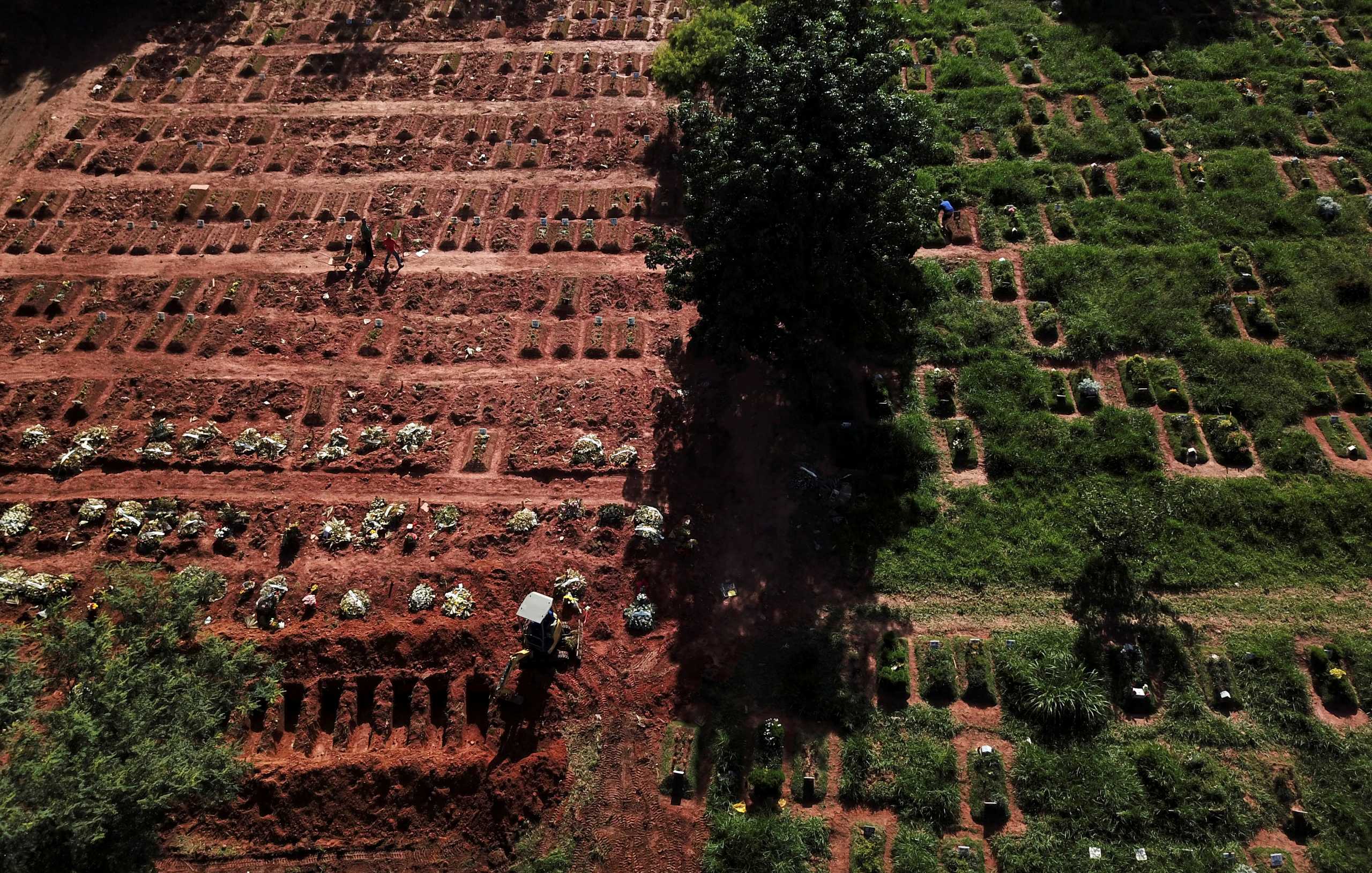Aerial view of an excavator opening graves on the last piece of land as new burials are suspended, except private deposits and children, at Vila Nova Cachoeirinha cemetery amid the outbreak of the coronavirus disease (COVID-19) in Sao Paulo, Brazil, April 1, 2021. Picture taken with a drone. REUTERS