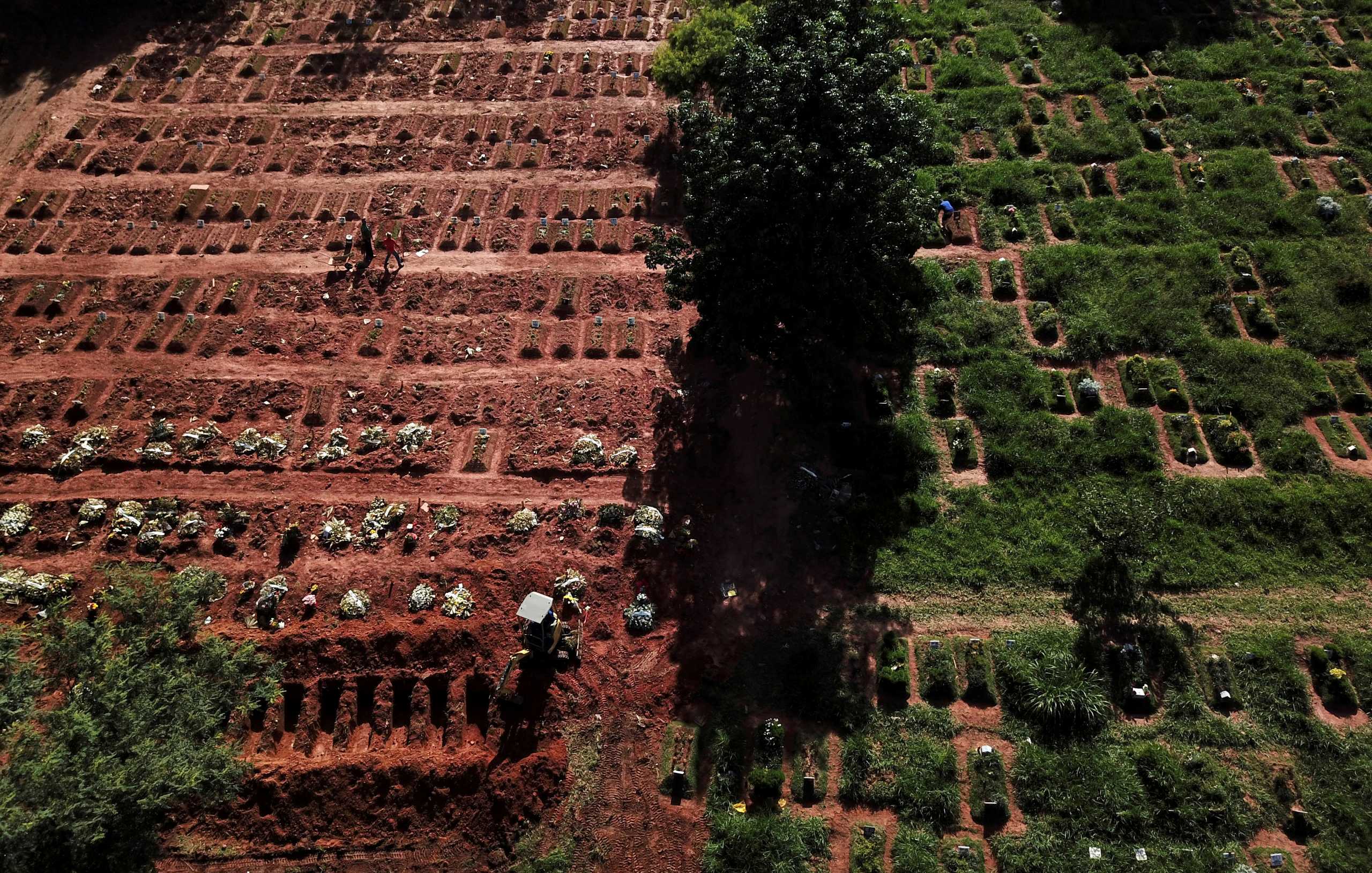 FILE PHOTO: Aerial view of an excavator opening graves on the last piece of land as new burials are suspended, except private deposits and children, at Vila Nova Cachoeirinha cemetery amid the outbreak of the coronavirus disease (COVID-19) in Sao Paulo, Brazil, April 1, 2021. Picture taken with a drone. REUTERS
