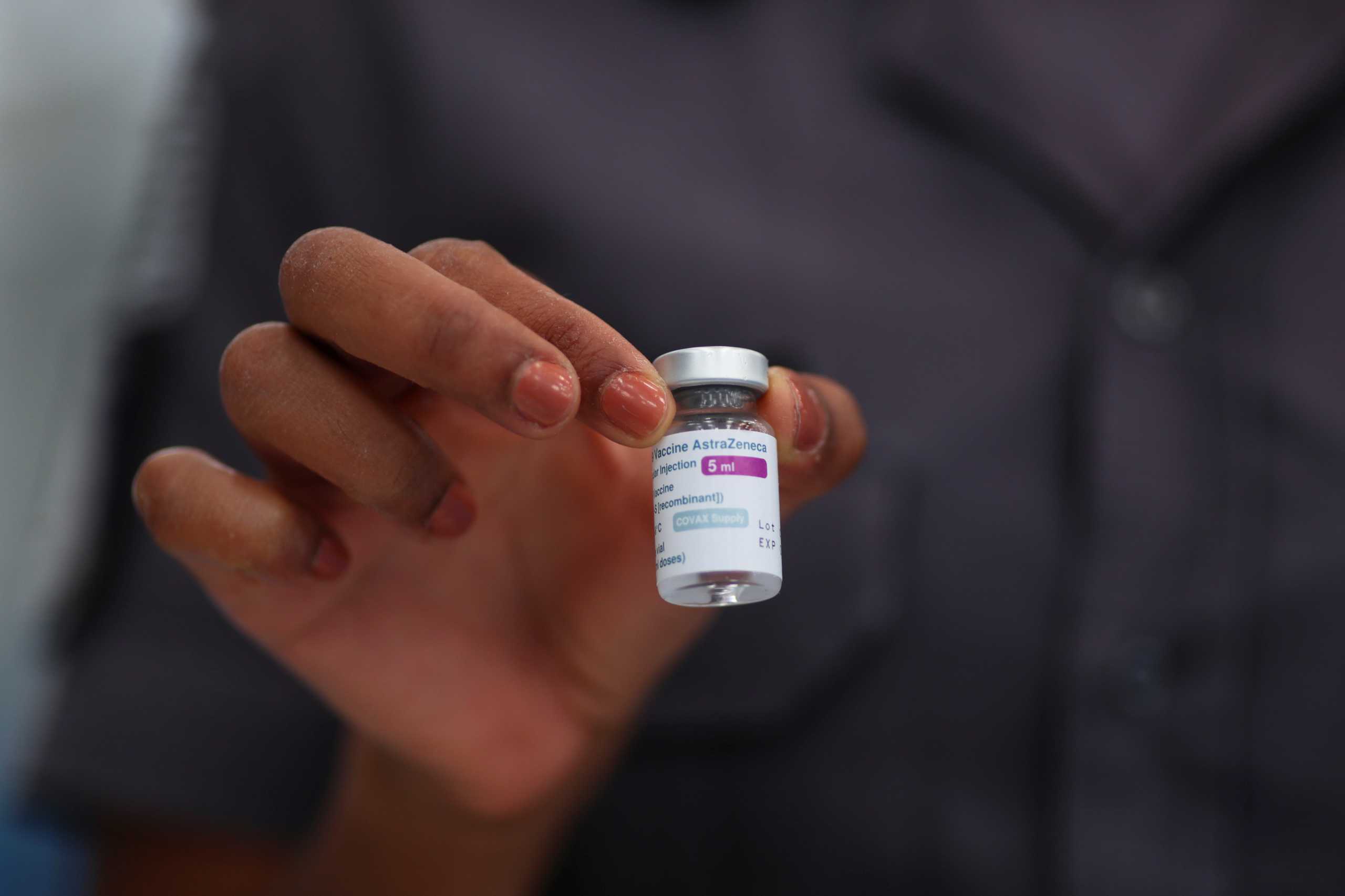 A police officer holds a vial of AstraZeneca's coronavirus disease (COVID-19) vaccine on the first day of state government vaccination for police officers, at Barro Branco Military Police Academy in Sao Paulo, Brazil April 5, 2021. REUTERS