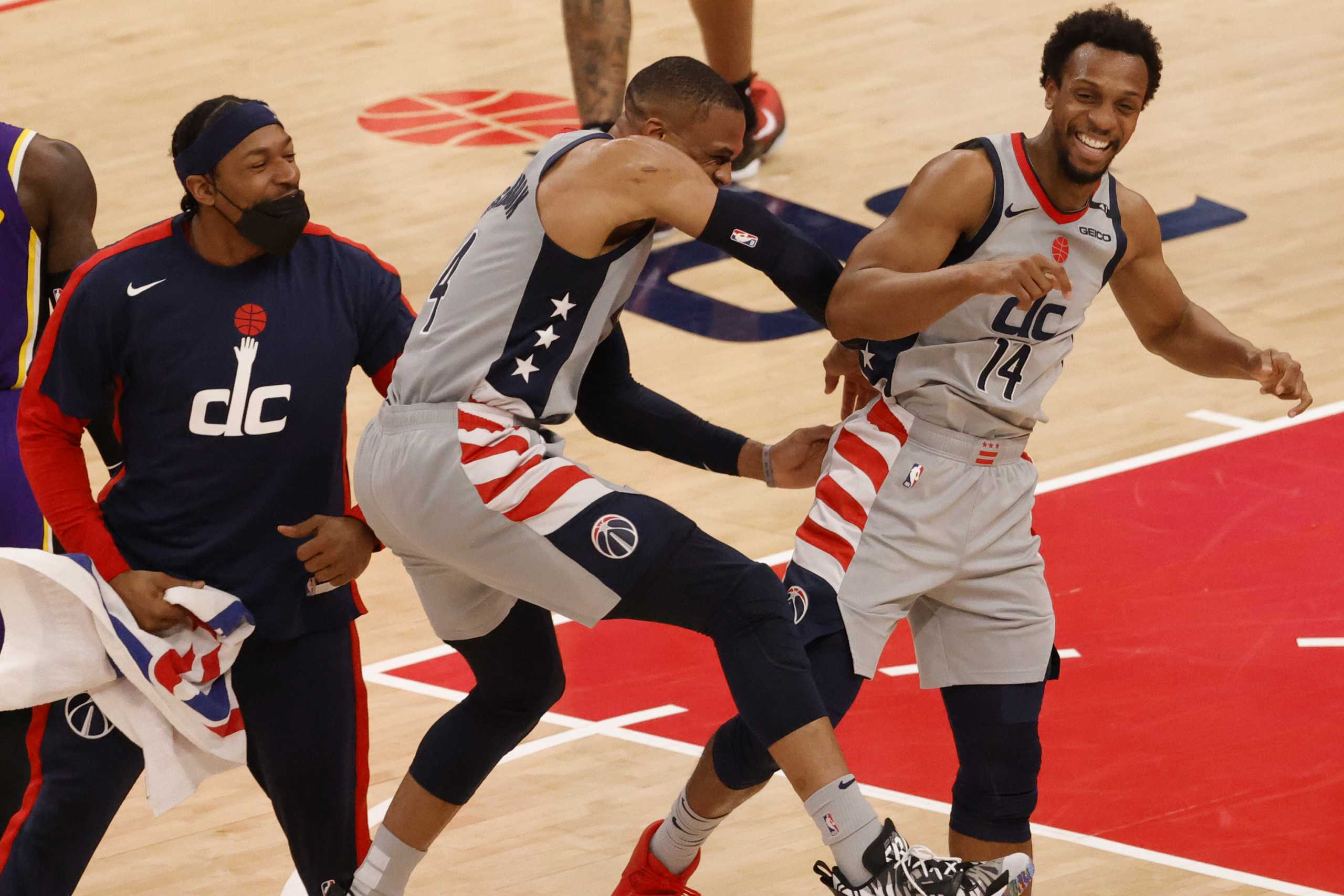 Apr 28, 2021; Washington, District of Columbia, USA; Washington Wizards guard Ish Smith (14) celebrates with Wizards guard Russell Westbrook (4) and Wizards guard Bradley Beal (L) against the Los Angeles Lakers in the fourth quarter at Capital One Arena. Mandatory Credit: Geoff Burke-USA TODAY Sports