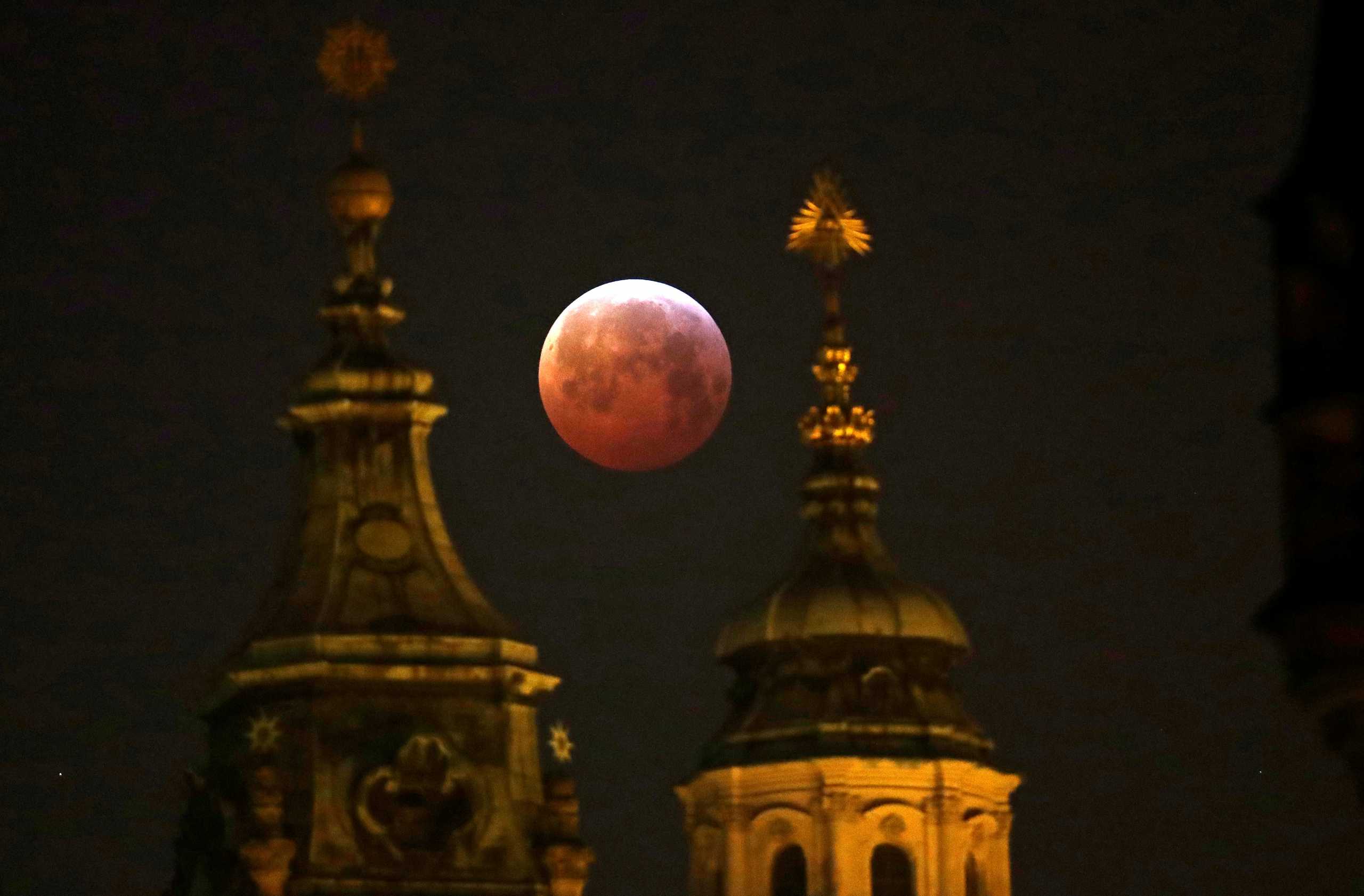 FILE PHOTO: The "Super Blood Wolf Moon" is seen during a lunar eclipse in Prague, Czech Republic, January 21, 2019.  REUTERS