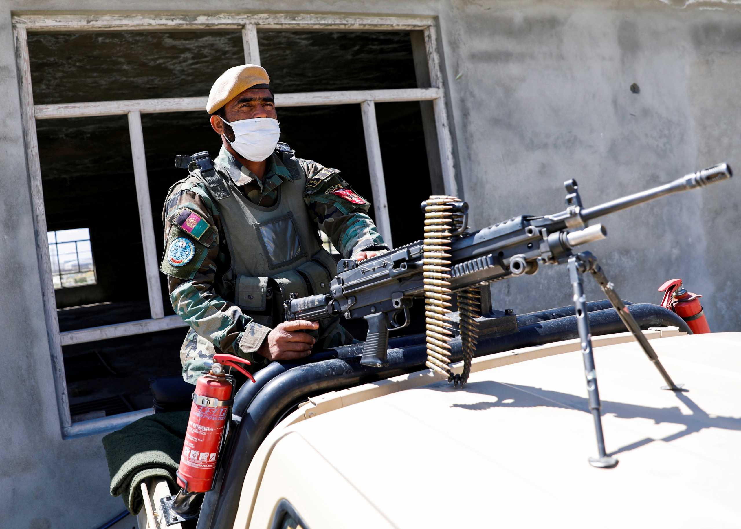 FILE PHOTO: An Afghan National Army soldier sits on a back of an army vehicle at a checkpoint on the outskirts of Kabul, Afghanistan April 21, 2021. REUTERS