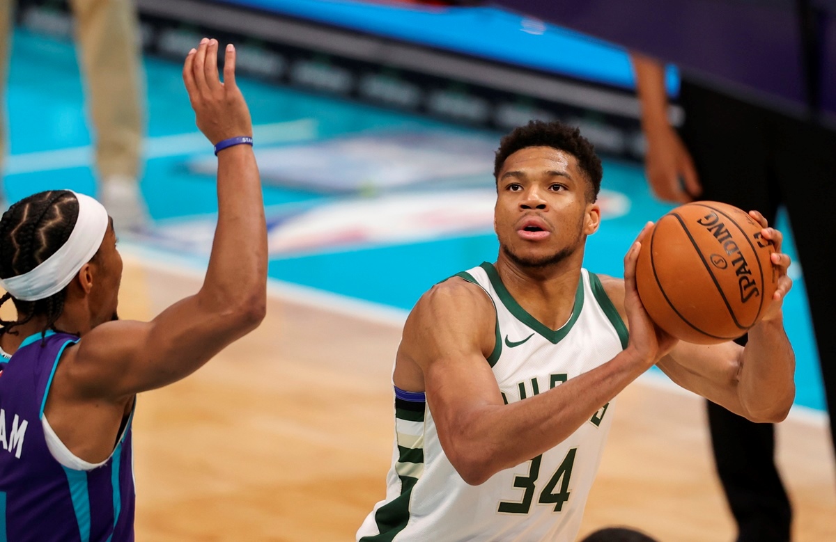 Apr 27, 2021; Charlotte, North Carolina, USA; Milwaukee Bucks forward Giannis Antetokounmpo (34) looks to shoot against Charlotte Hornets guard Devonte' Graham (4) during the third quarter at Spectrum Center. Mandatory Credit: Nell Redmond-USA TODAY Sports