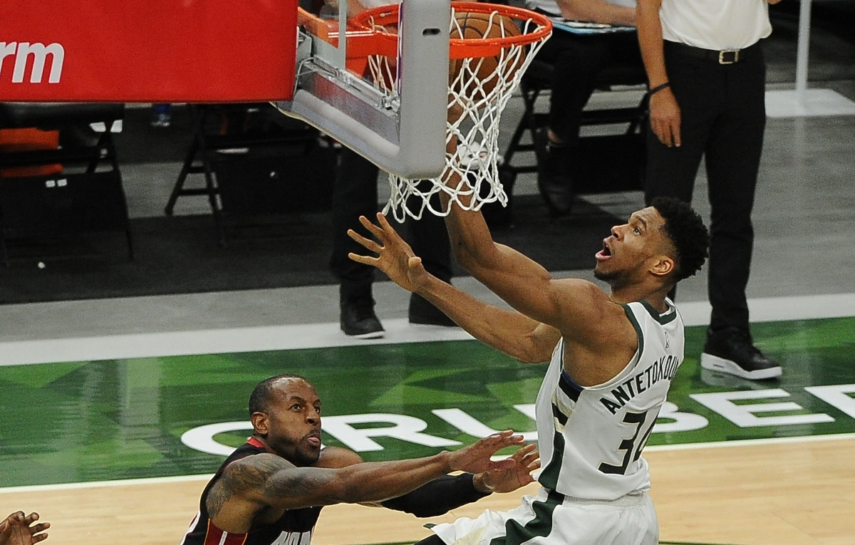 May 15, 2021; Milwaukee, Wisconsin, USA;  Milwaukee Bucks forward Giannis Antetokounmpo (34) is fouled while driving to the basket by Miami Heat forward Andre Iguodala (28) in the third quarter at Fiserv Forum. Mandatory Credit: Michael McLoone-USA TODAY Sports