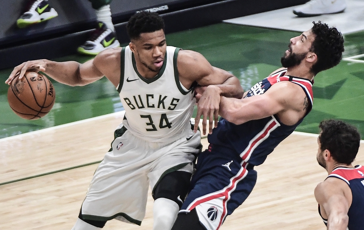 May 5, 2021; Milwaukee, Wisconsin, USA;  Milwaukee Bucks forward Giannis Antetokounmpo (34) tries to get past Washington Wizards forward Anthony Gill (16) in the first quarter at Fiserv Forum. Mandatory Credit: Benny Sieu-USA TODAY Sports