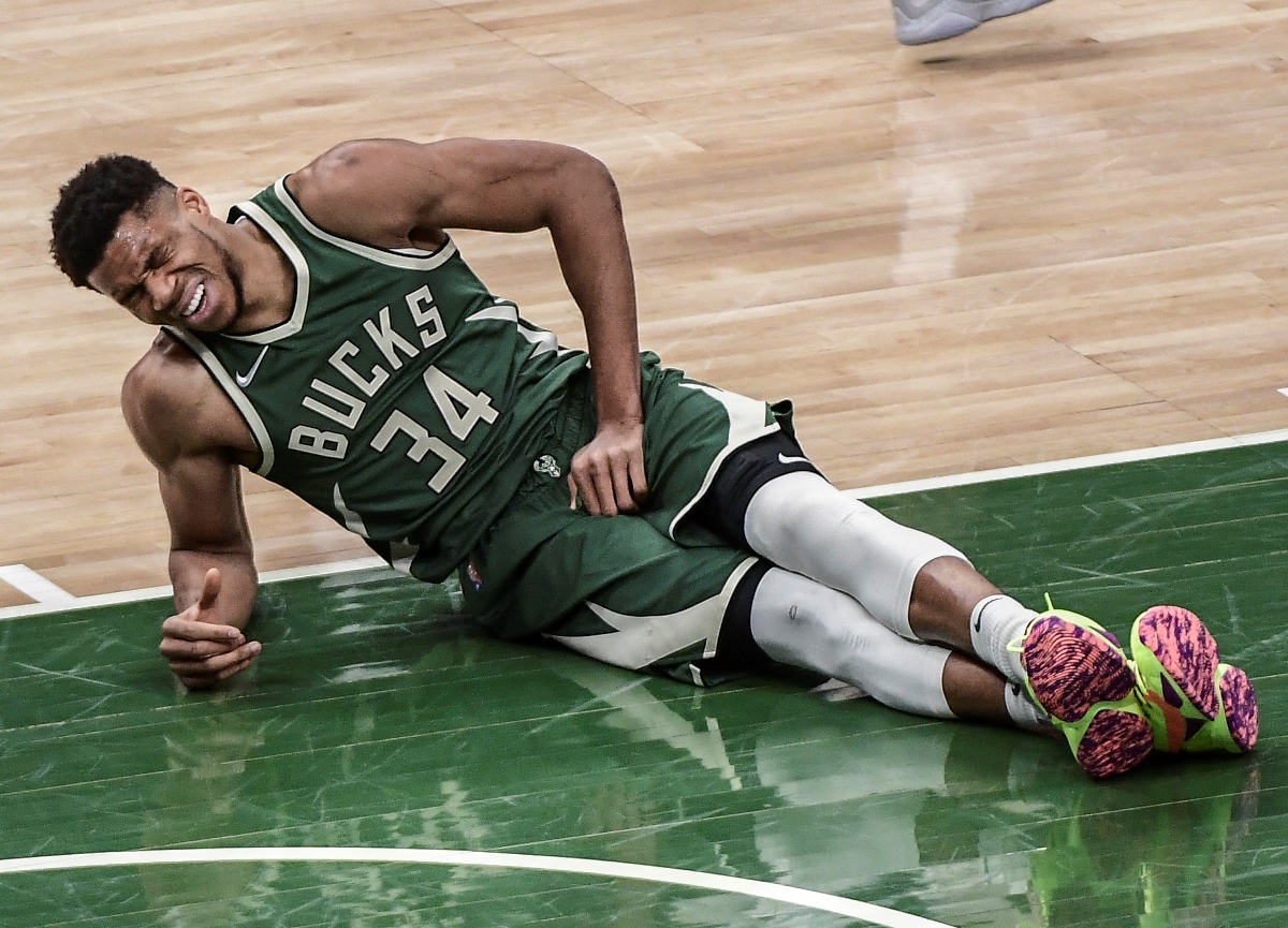 May 11, 2021; Milwaukee, Wisconsin, USA; Milwaukee Bucks forward Giannis Antetokounmpo (34) lays on the floor after a collision during the first quarter against the Orlando Magic at Fiserv Forum. Mandatory Credit: Benny Sieu-USA TODAY Sports