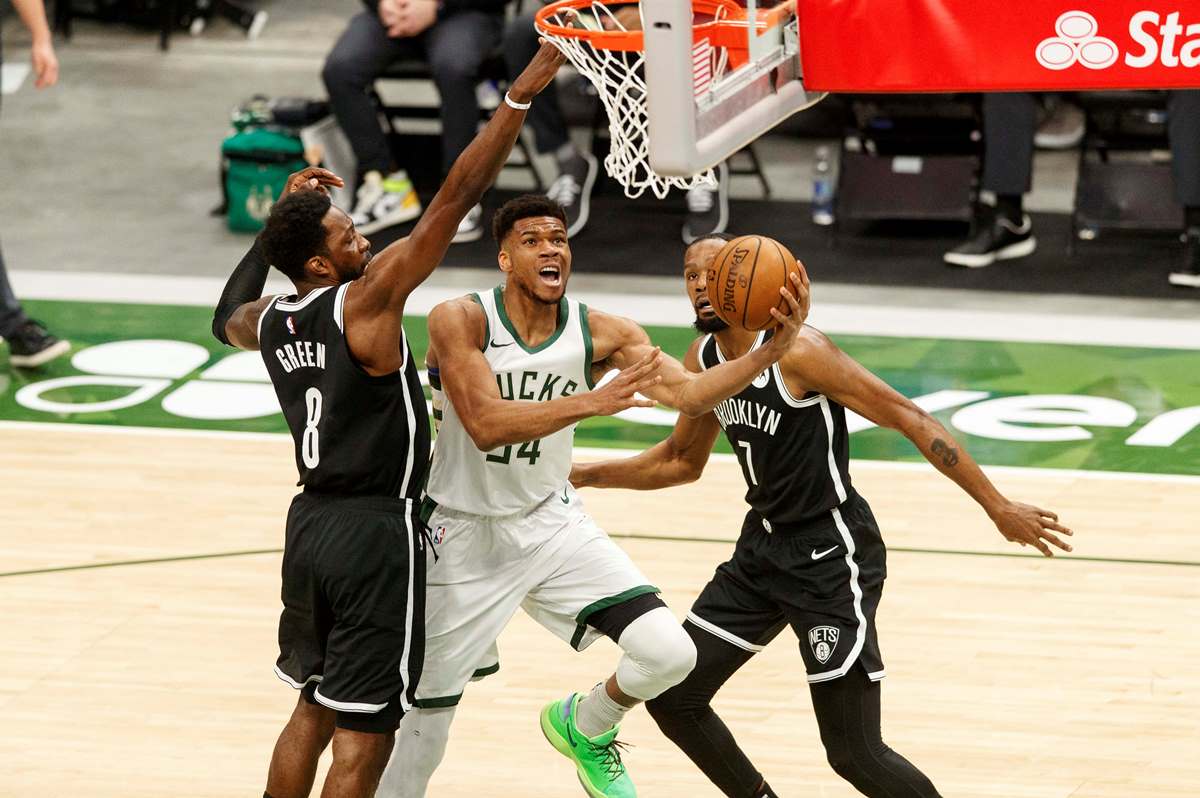 May 4, 2021; Milwaukee, Wisconsin, USA;  Milwaukee Bucks forward Giannis Antetokounmpo (34) shoots between Brooklyn Nets forward Jeff Green (8) and forward Kevin Durant (7) during the first quarter at Fiserv Forum. Mandatory Credit: Jeff Hanisch-USA TODAY Sports