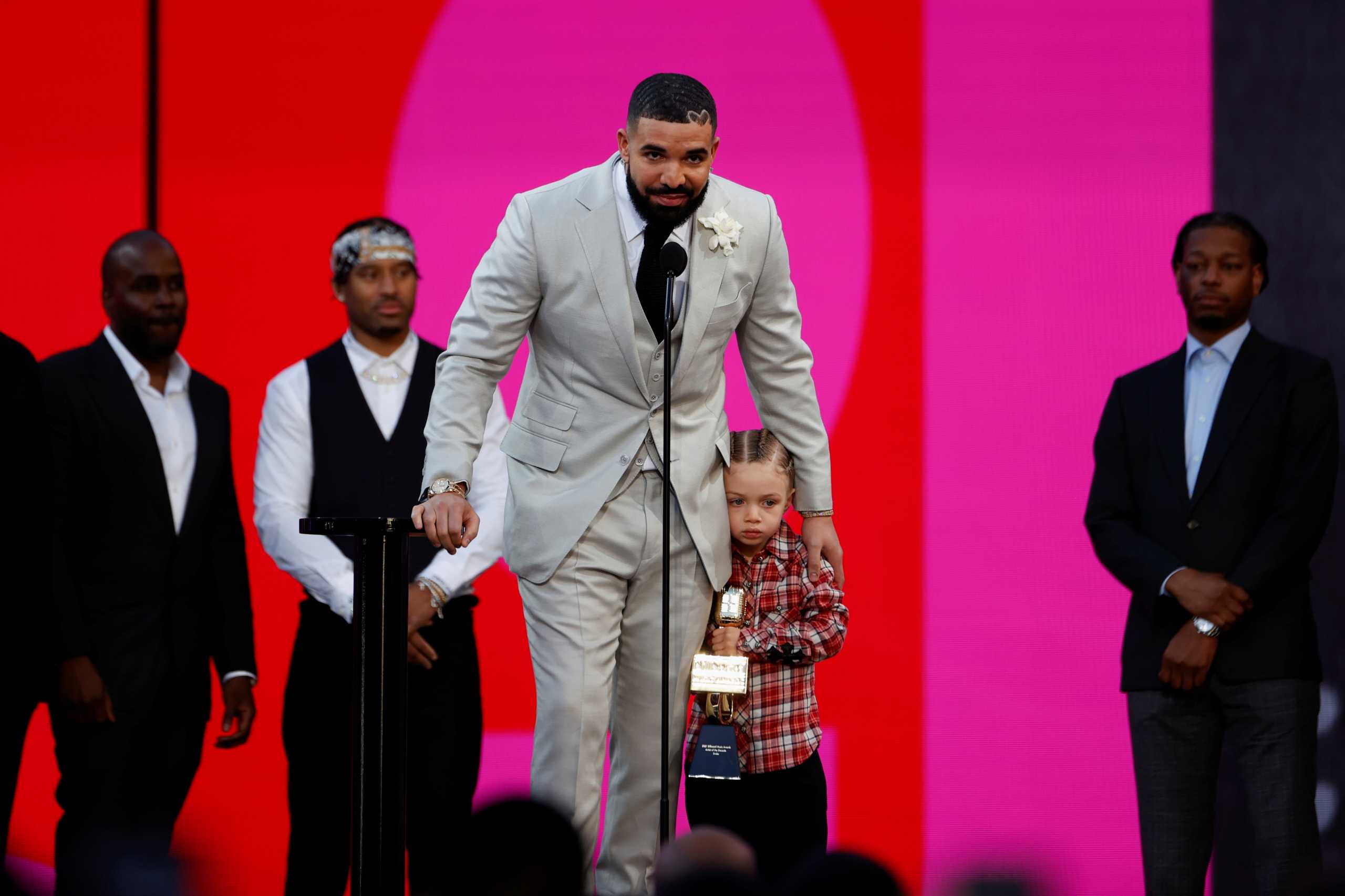 Drake, accompanied by his son Adonis, accepts the award for Artist of the Decade at the 2021 Billboard Music Awards outside the Microsoft Theater in Los Angeles, California, U.S., May 23, 2021. REUTERS