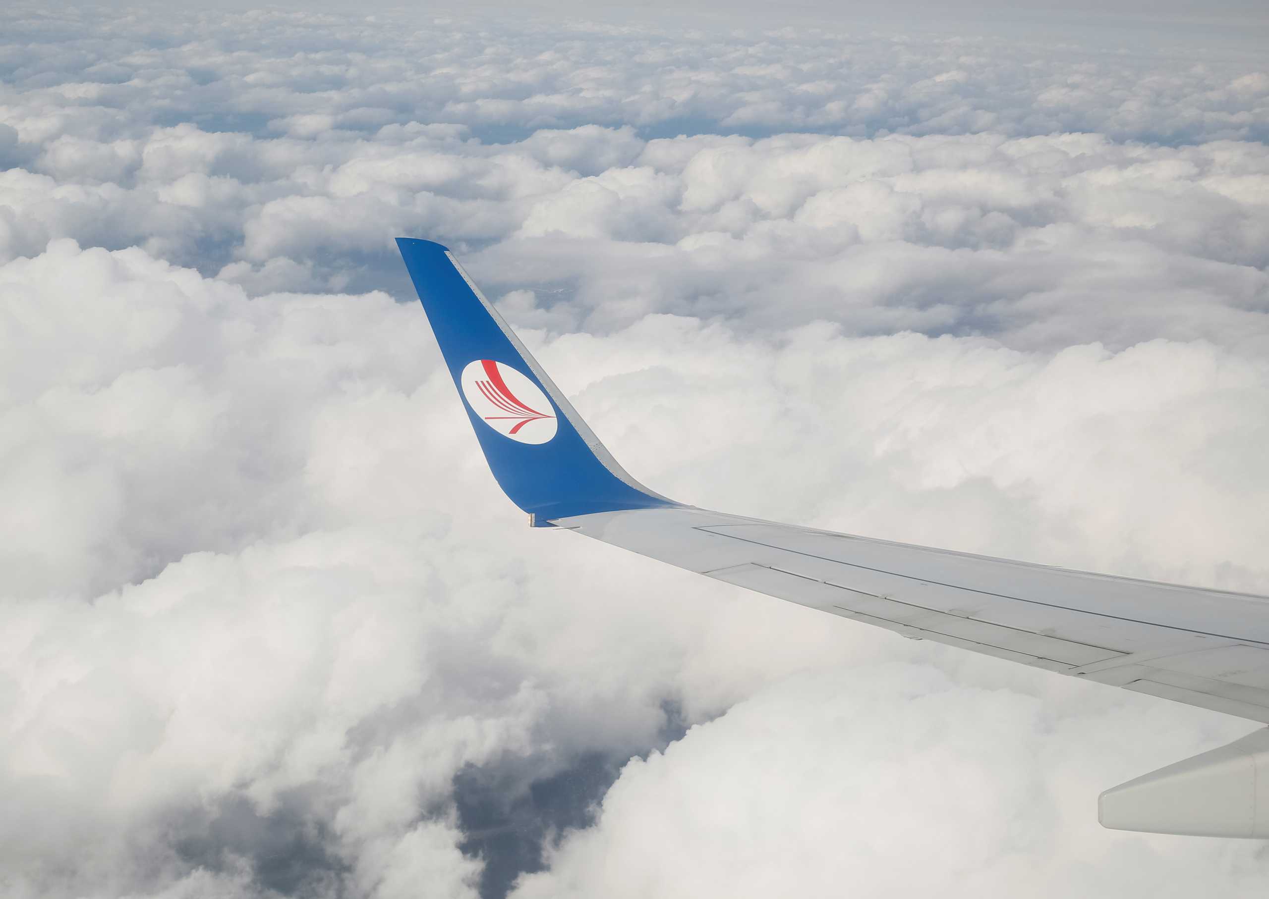 FILE PHOTO: A wing of a plane of Belavia company is seen over clouds near Minsk, Belarus, July 19, 2016.  REUTERS