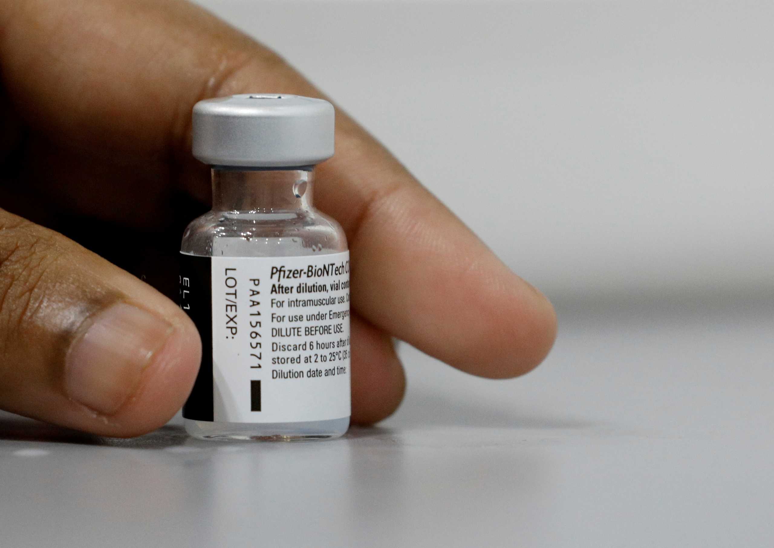 FILE PHOTO: A medical worker prepares to dilute a vial of Pfizer-BioNTech vaccine at a coronavirus disease (COVID-19) vaccination center in Singapore March 8, 2021. REUTERS