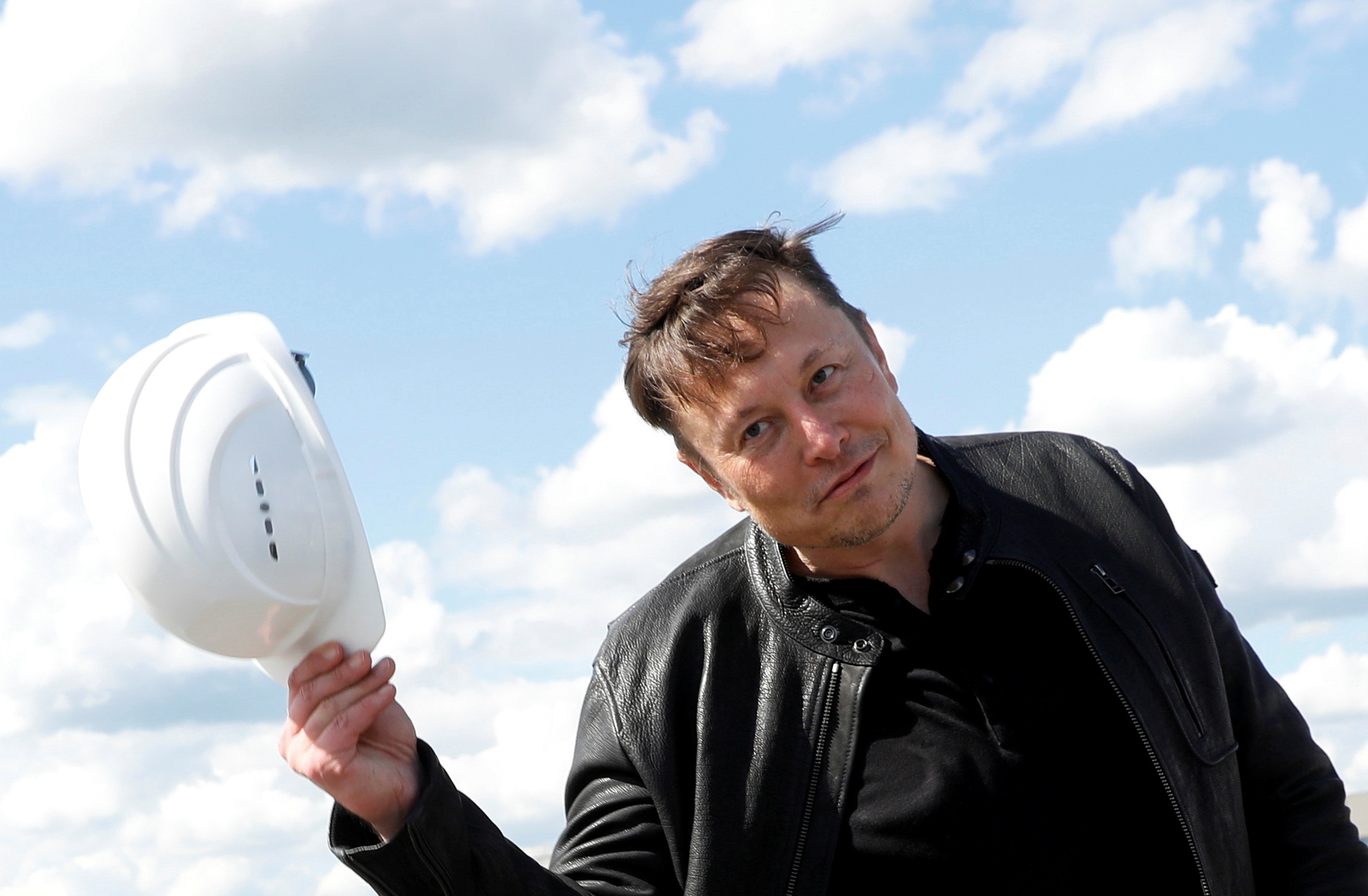 SpaceX founder and Tesla CEO Elon Musk holds a helmet as he visits the construction site of Tesla's gigafactory in Gruenheide, near Berlin, Germany, May 17, 2021. REUTERS