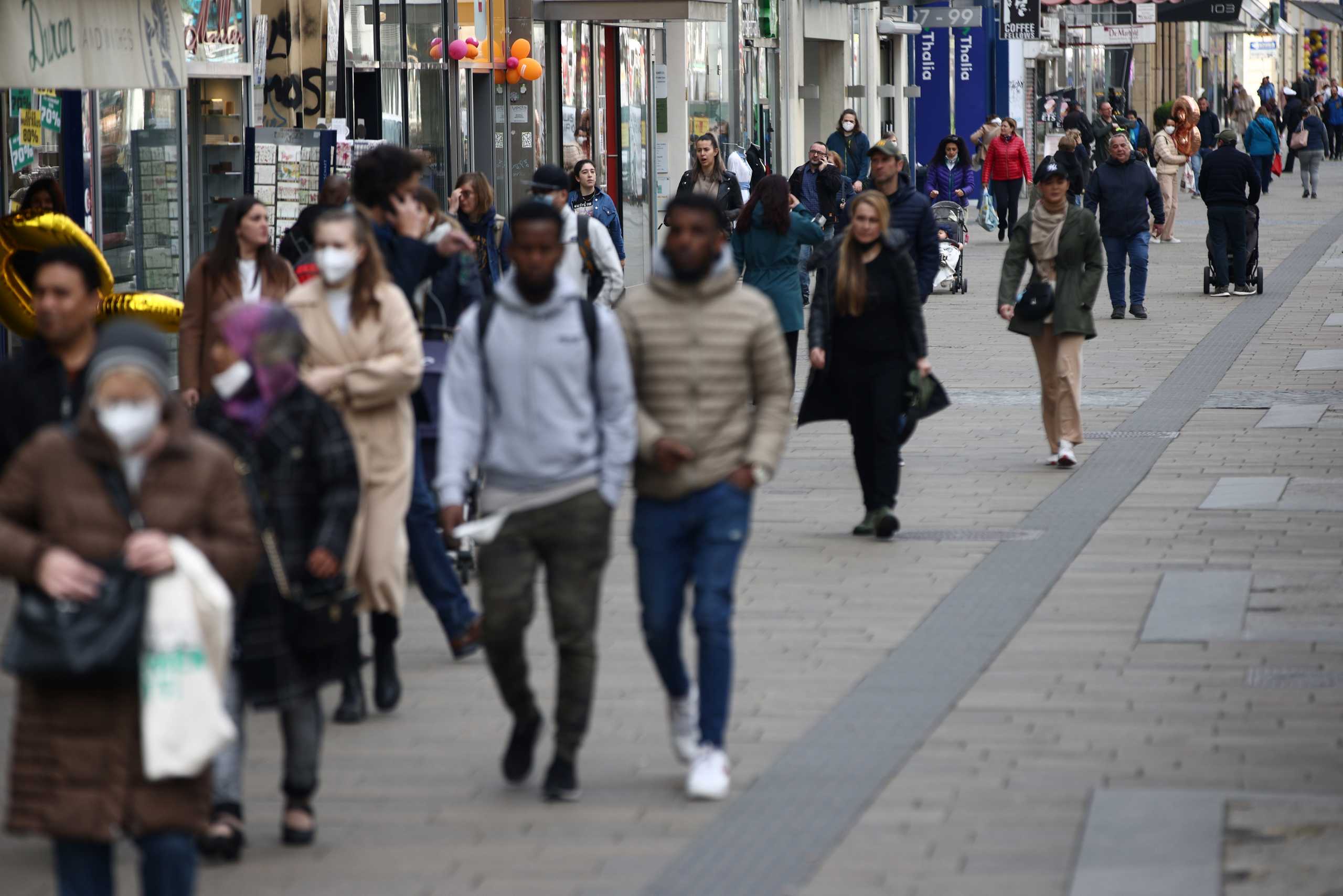 People walk along a shopping street as shops reopened after lockdown was loosened during the coronavirus (COVID-19) pandemic in Vienna, Austria, May 3, 2021. REUTERS