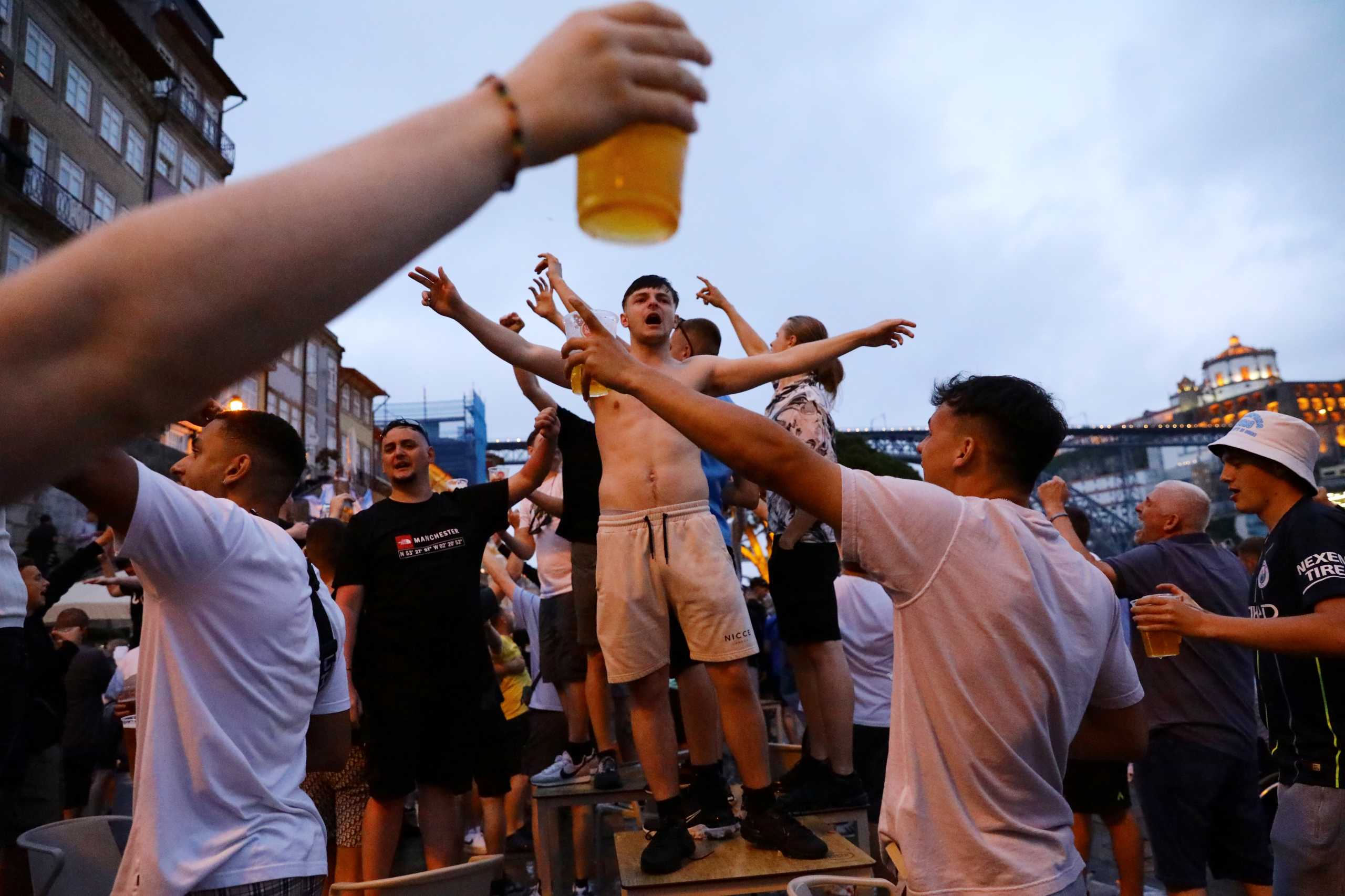 FILE PHOTO: Soccer Football - Champions League - Fans in Porto ahead of the Champions League Final Manchester City v Chelsea - Porto, Portugal - May 28, 2021 Manchester City fans in Porto ahead of the Champions League Final REUTERS