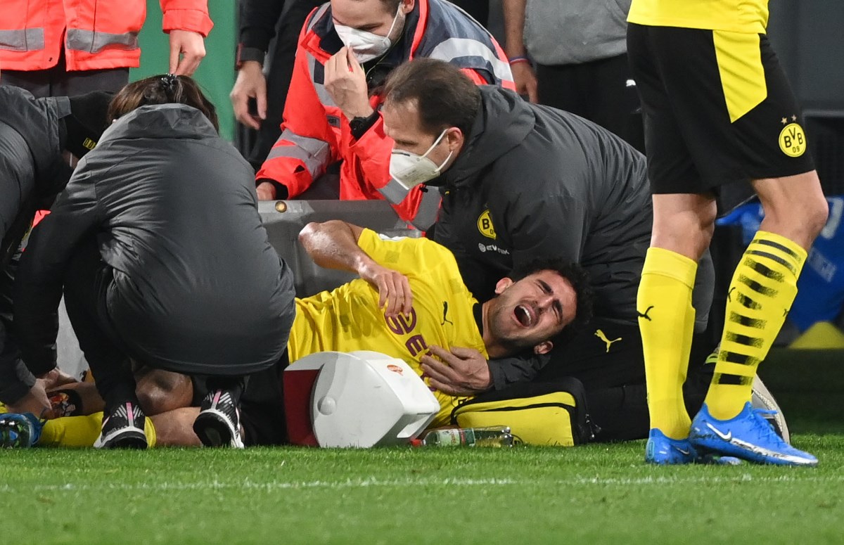Soccer Football - DFB Cup - Semi Final - Borussia Dortmund v Holstein Kiel - Signal Iduna Park, Dortmund, Germany - May 1, 2021 Borussia Dortmund's Mateu Morey receives medical attention after sustaining an injury Pool via REUTERS