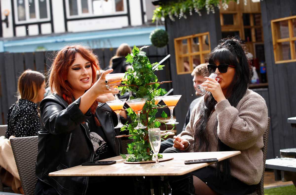 Customers at The Swinging Witch pub enjoy drinks, as lockdown eases amid the coronavirus disease (COVID-19) pandemic, in Northwich, Cheshire, Britain, May 15, 2021. REUTERS
