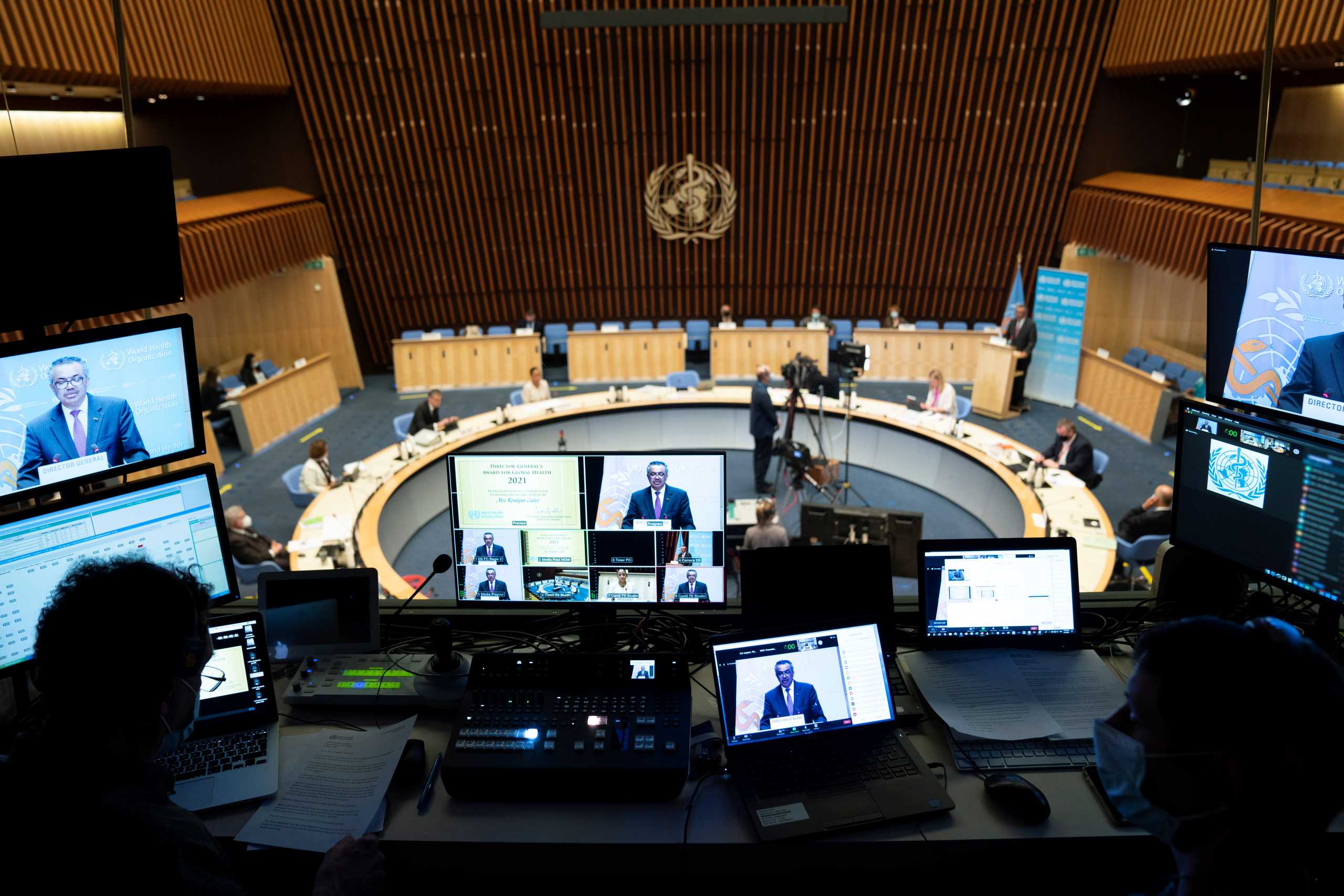 World Health Organization (WHO) Director General Tedros Adhanom Ghebreyesus is seen on screens as he attends the World Health Assembly (WHA) amid the coronavirus disease (COVID-19) pandemic in Geneva, Switzerland, May 24, 2021. Christopher Black