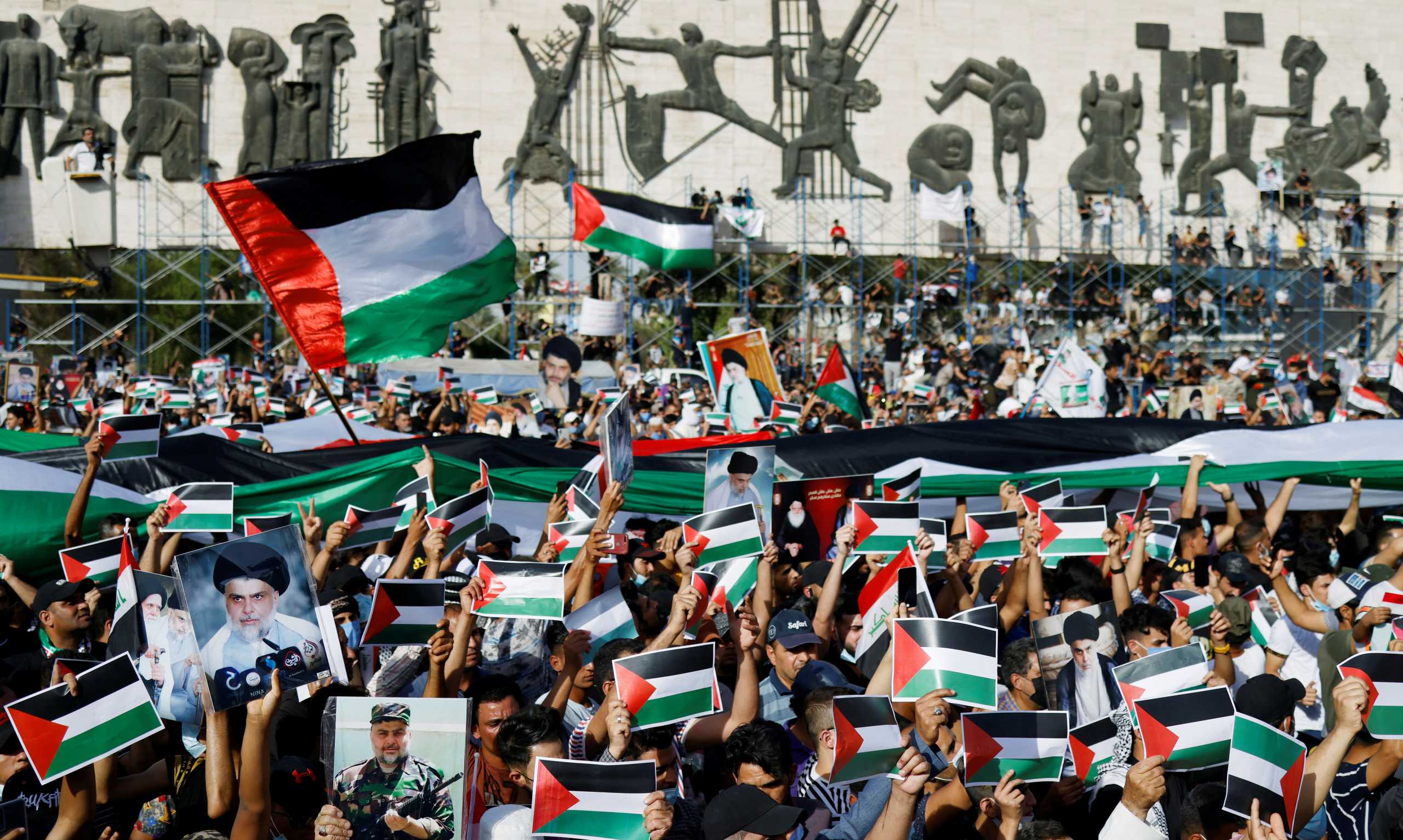 Iraqi demonstrators wave Palestinian flags during a protest to express solidarity with the Palestinian people amid a flare-up of Israeli-Palestinian violence, in Baghdad, Iraq May 15, 2021. REUTERS