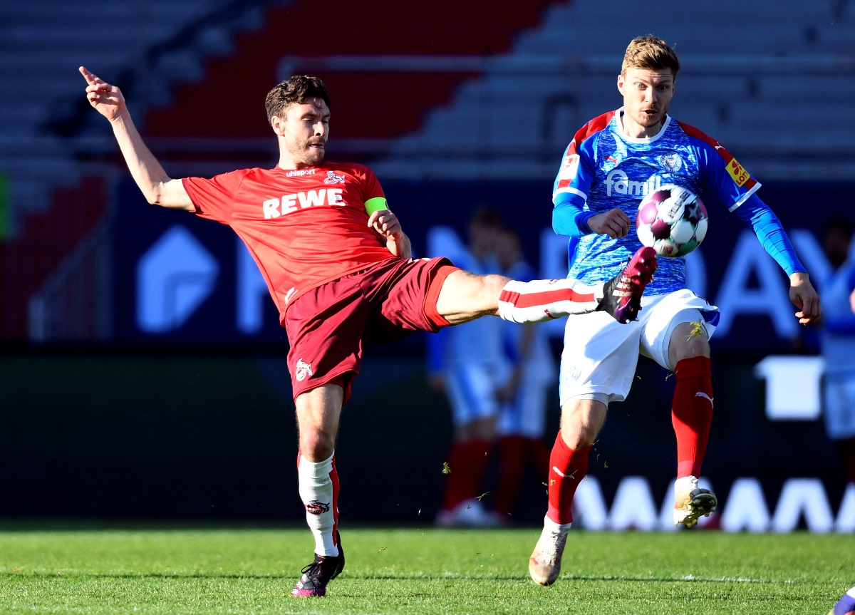 Soccer Football - Bundesliga Playoff - Second Leg - Holstein Kiel v FC Cologne - Holstein-Stadion, Kiel, Germany - May 29, 2021 FC Cologne's Jonas Hector in action with Holstein Kiel's Alexander Muhling REUTERS