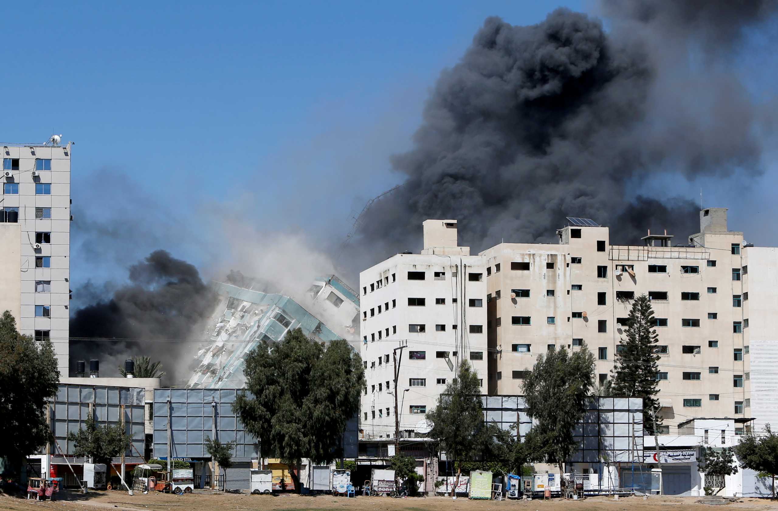 A tower housing AP, Al Jazeera offices collapses after Israeli missile strikes in Gaza city, May 15, 2021. REUTERS