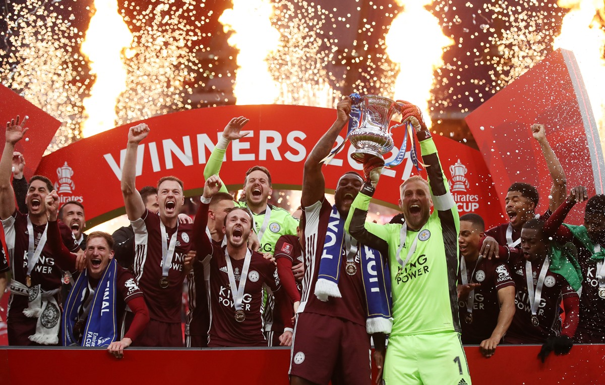 Soccer Football - FA Cup Final - Chelsea v Leicester City - Wembley Stadium, London, Britain - May 15, 2021 Leicester City's Kasper Schmeichel and Leicester City's Wes Morgan celebrates with the trophy after winning the FA Cup Pool via REUTERS