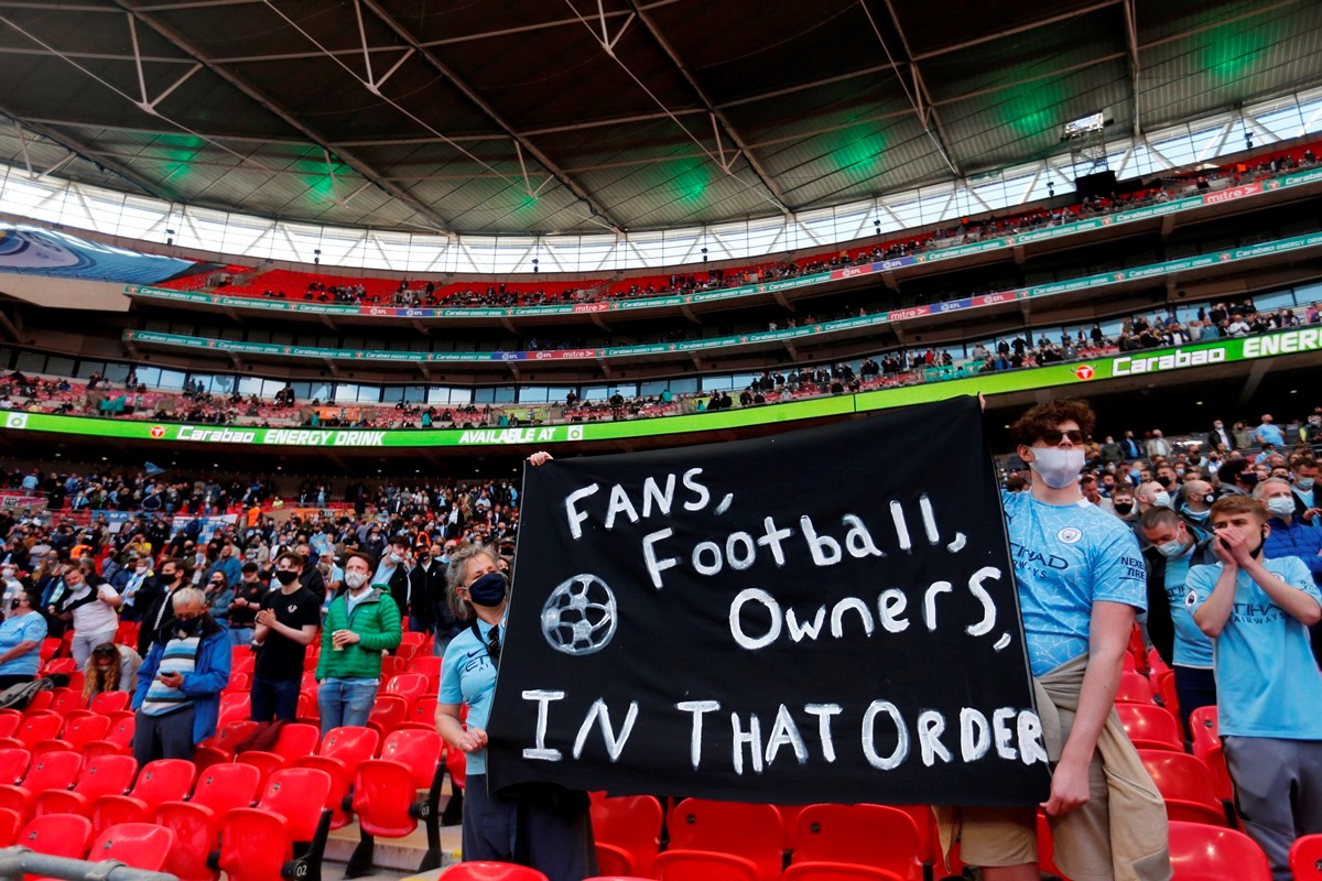 Soccer Football - Carabao Cup Final - Tottenham Hotspur v Manchester City - Wembley Stadium, London, Britain - April 25, 2021 Manchester City fans holding up signs at Manchester City board's involvement in the failed launch of a European Super League inside the stadium before the match as thousands of fans are permitted to attend the Carabao Cup Final, which is part of the UK Government’s Events Research Programme Pool via REUTERS