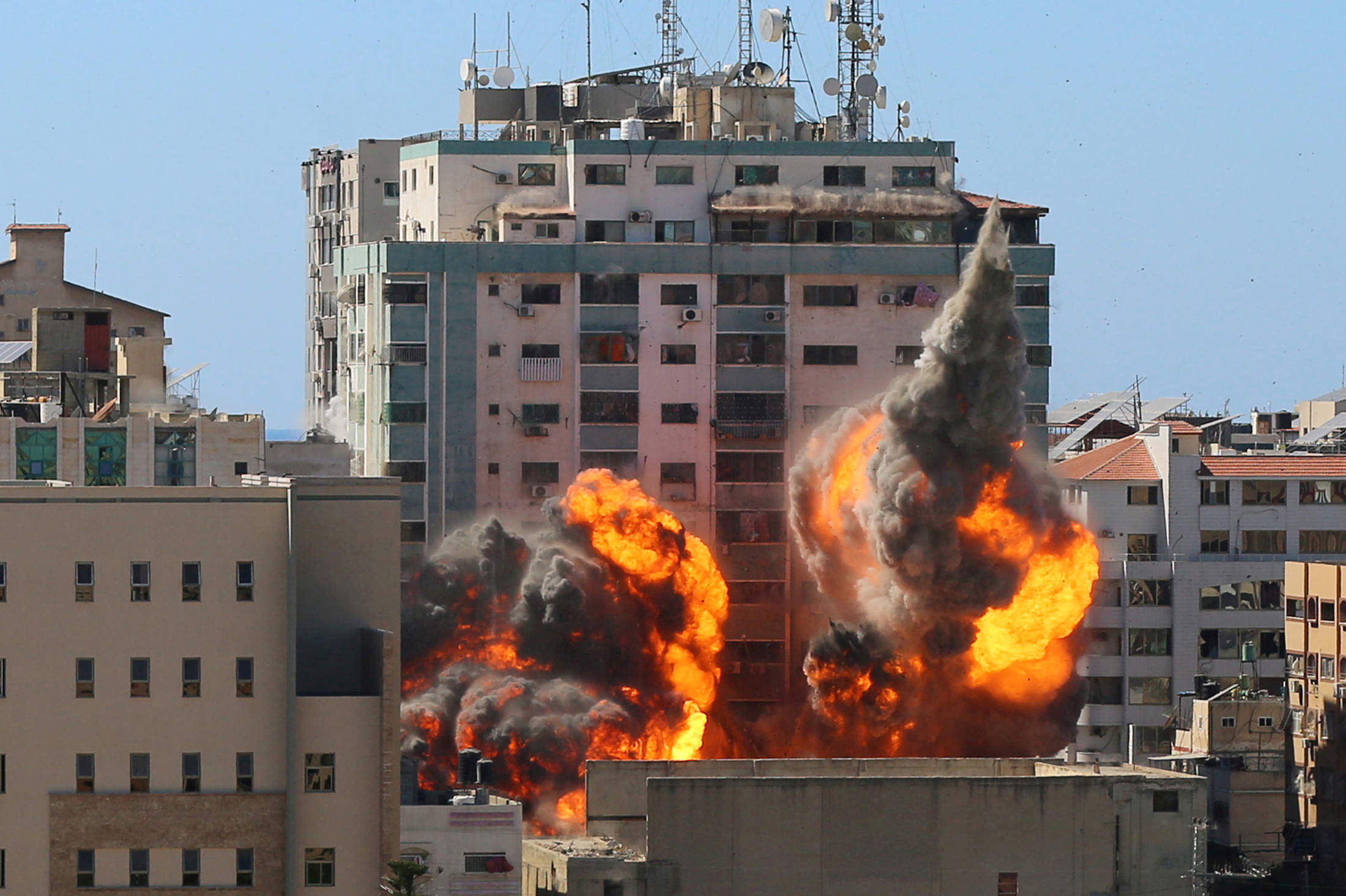 The al-Jalaa building housing Associated Press (AP) and Al Jazeera media offices is hit by an Israeli air strike in Gaza City, May 15, 2021. REUTERS
