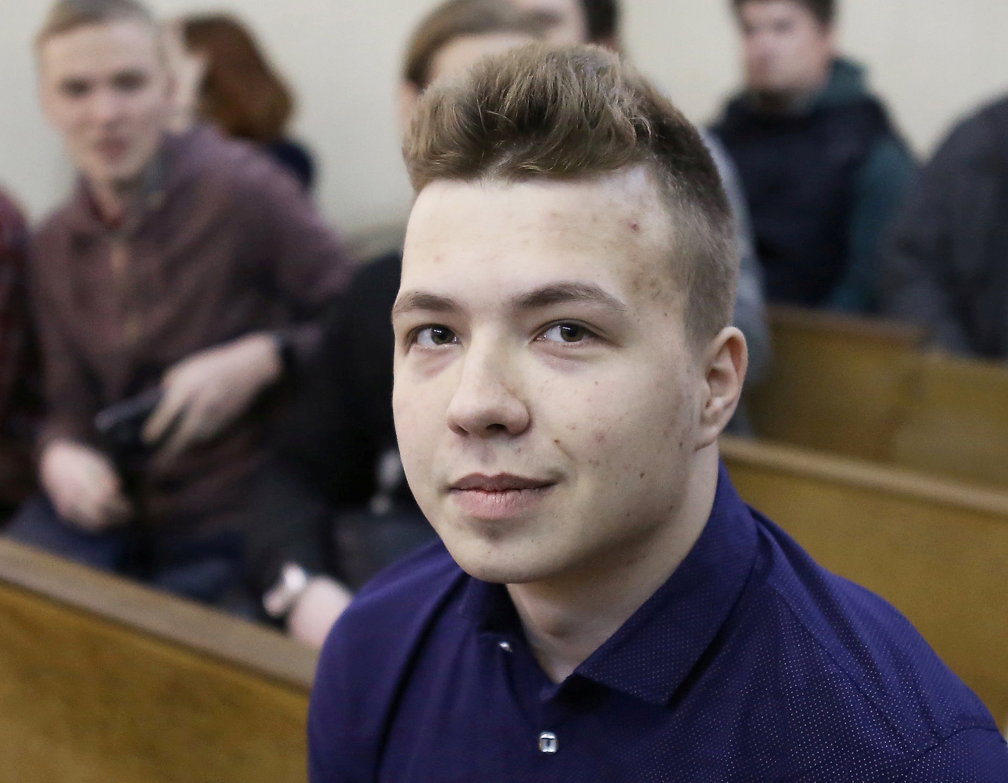 FILE PHOTO: Opposition blogger and activist Roman Protasevich, who is accused of participating in an unsanctioned protest at the Kuropaty preserve, waits before the beginning of a court hearing in Minsk, Belarus April 10, 2017. Picture taken April 10, 2017. REUTERS